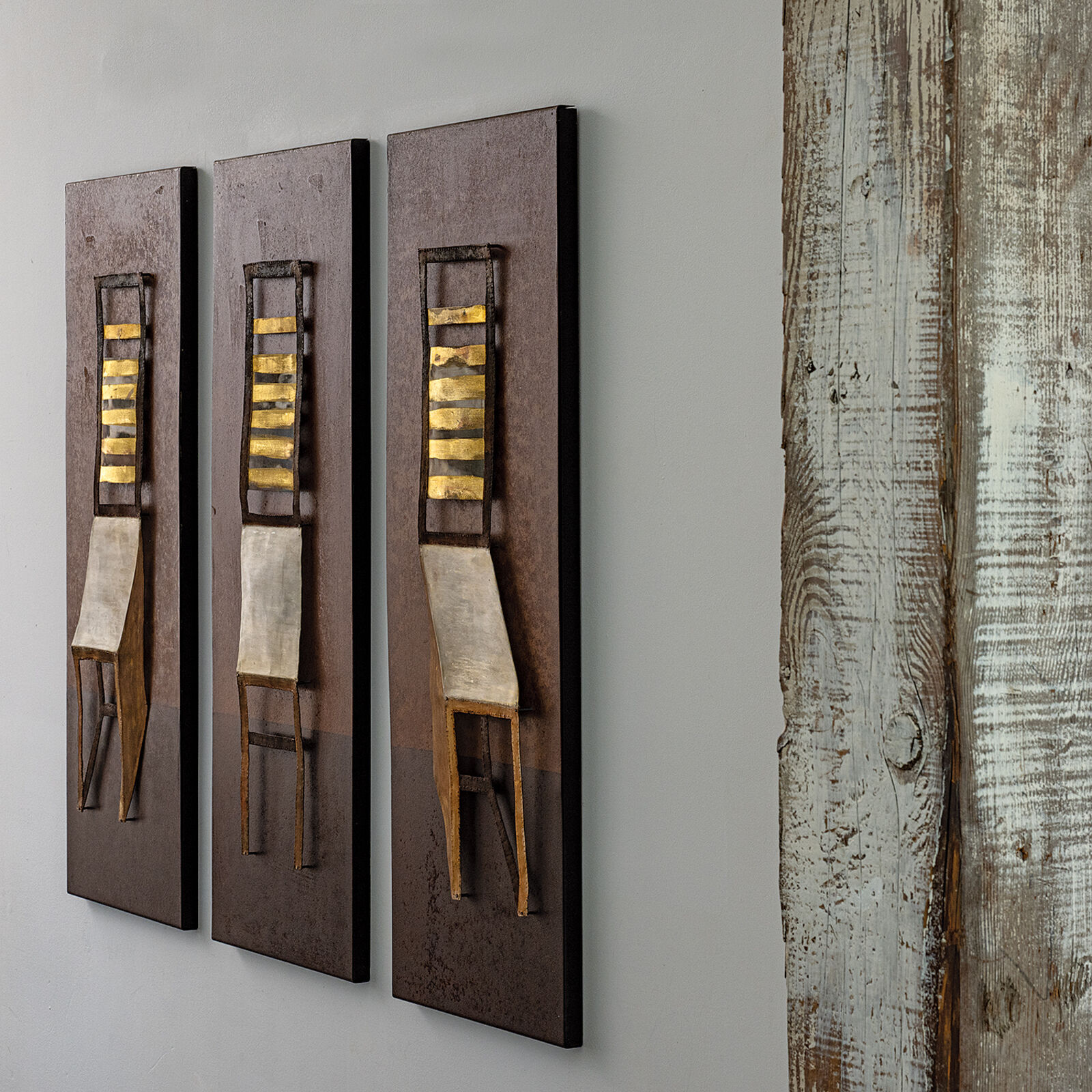 A triptych of minimalist chairs rendered in warm earth tones against a textured background.