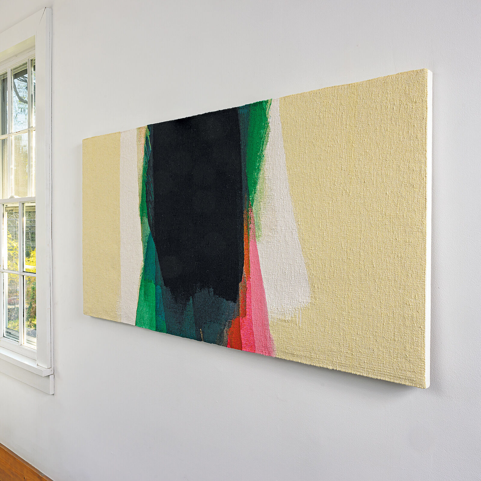 A minimalist abstract painting featuring a central black shape surrounded by vertical strokes of green, pink, and white against a pale yellow background.