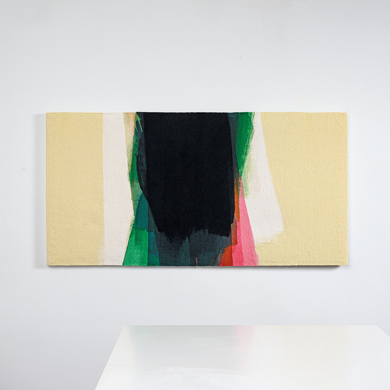 A minimalist abstract painting featuring a central black shape surrounded by vertical strokes of green, pink, and white against a pale yellow background.