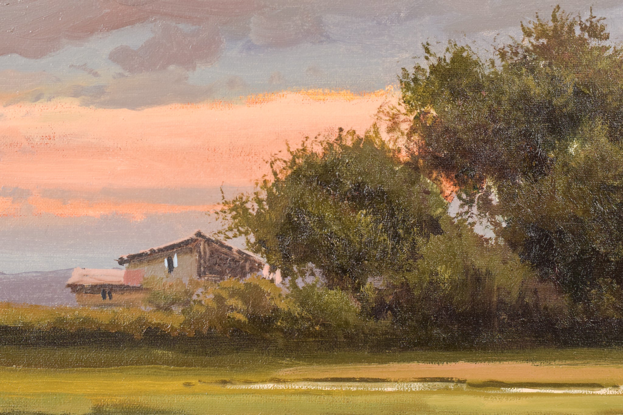 A painting of two people washing clothes in a river.