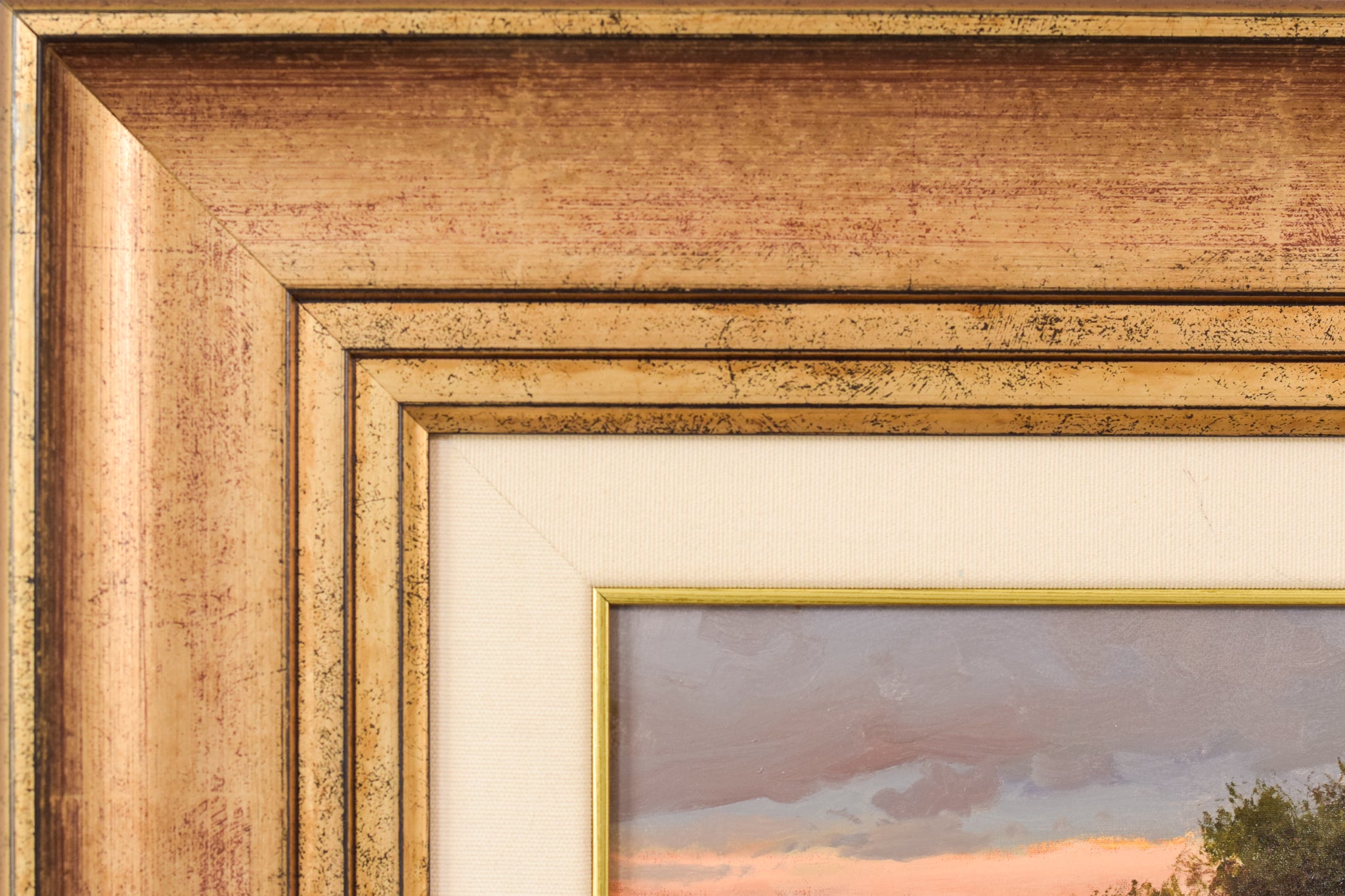 A painting of two people washing clothes in a river.