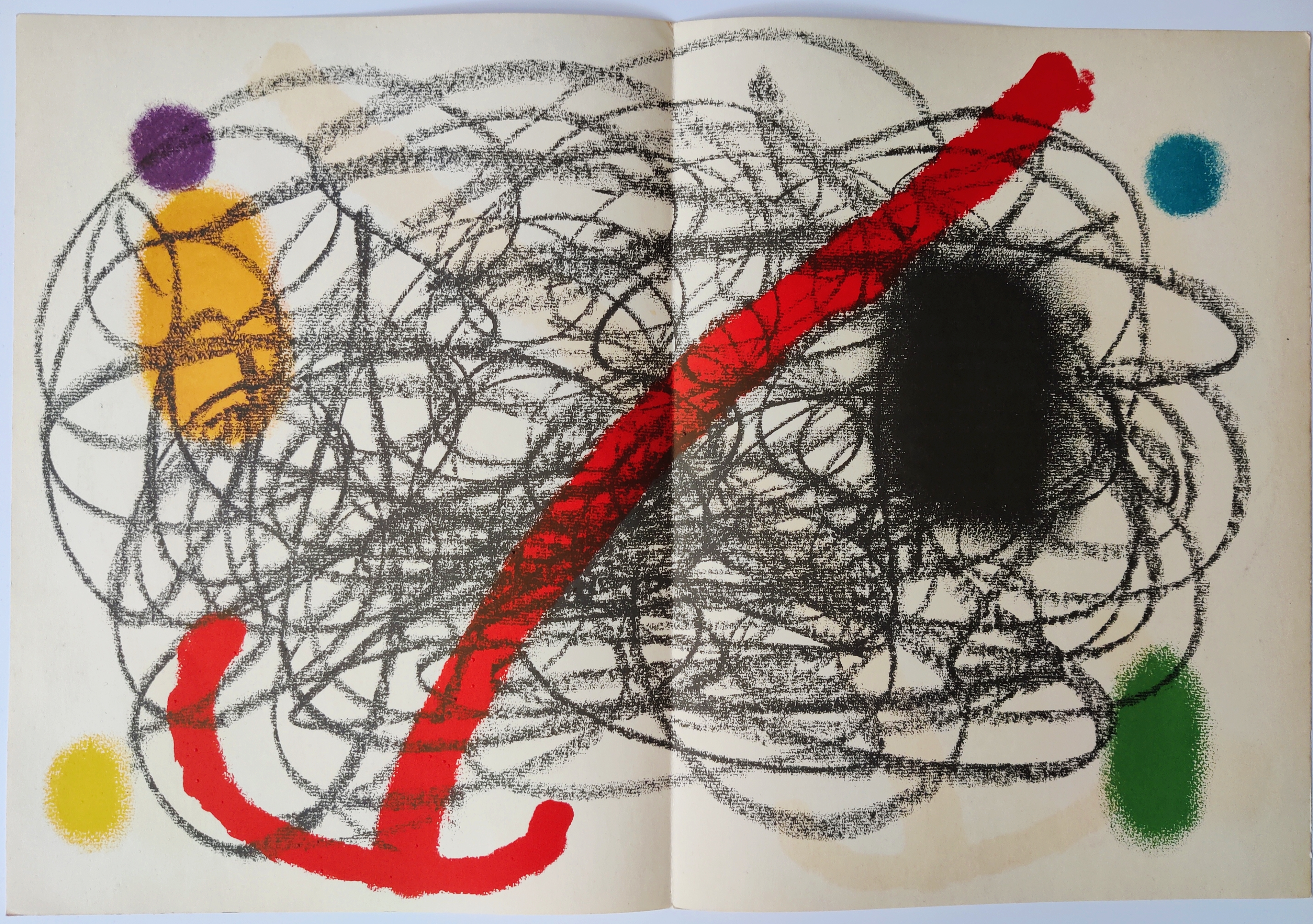 A book with a drawing of a red and black design on it.