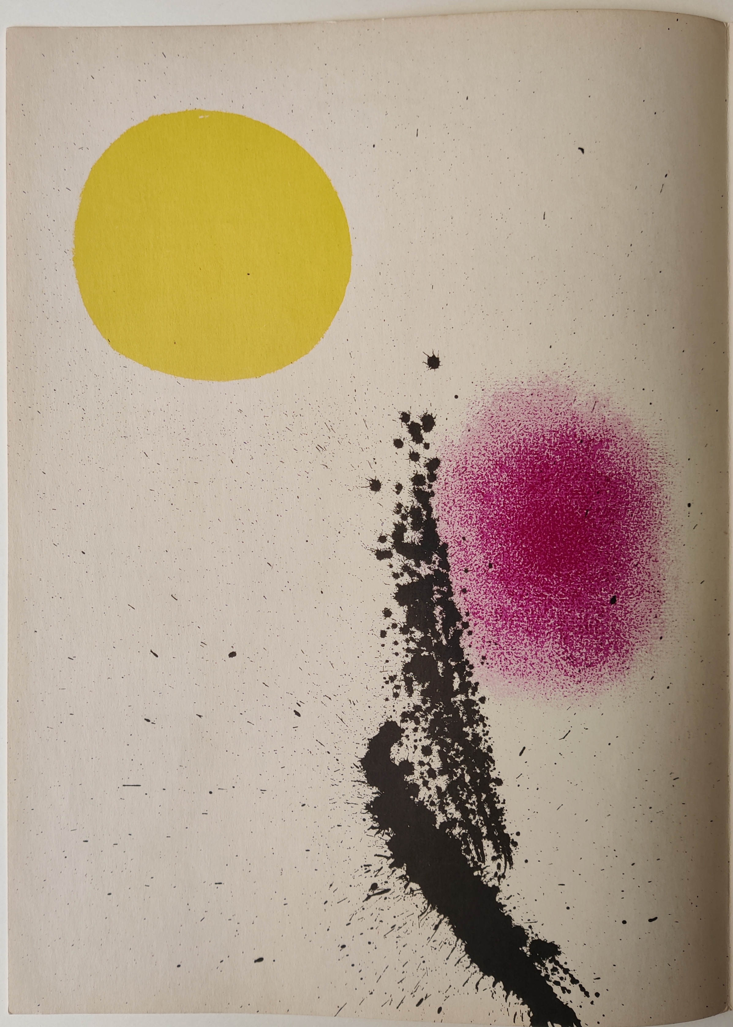 A book with a yellow circle and a pink dot on it.