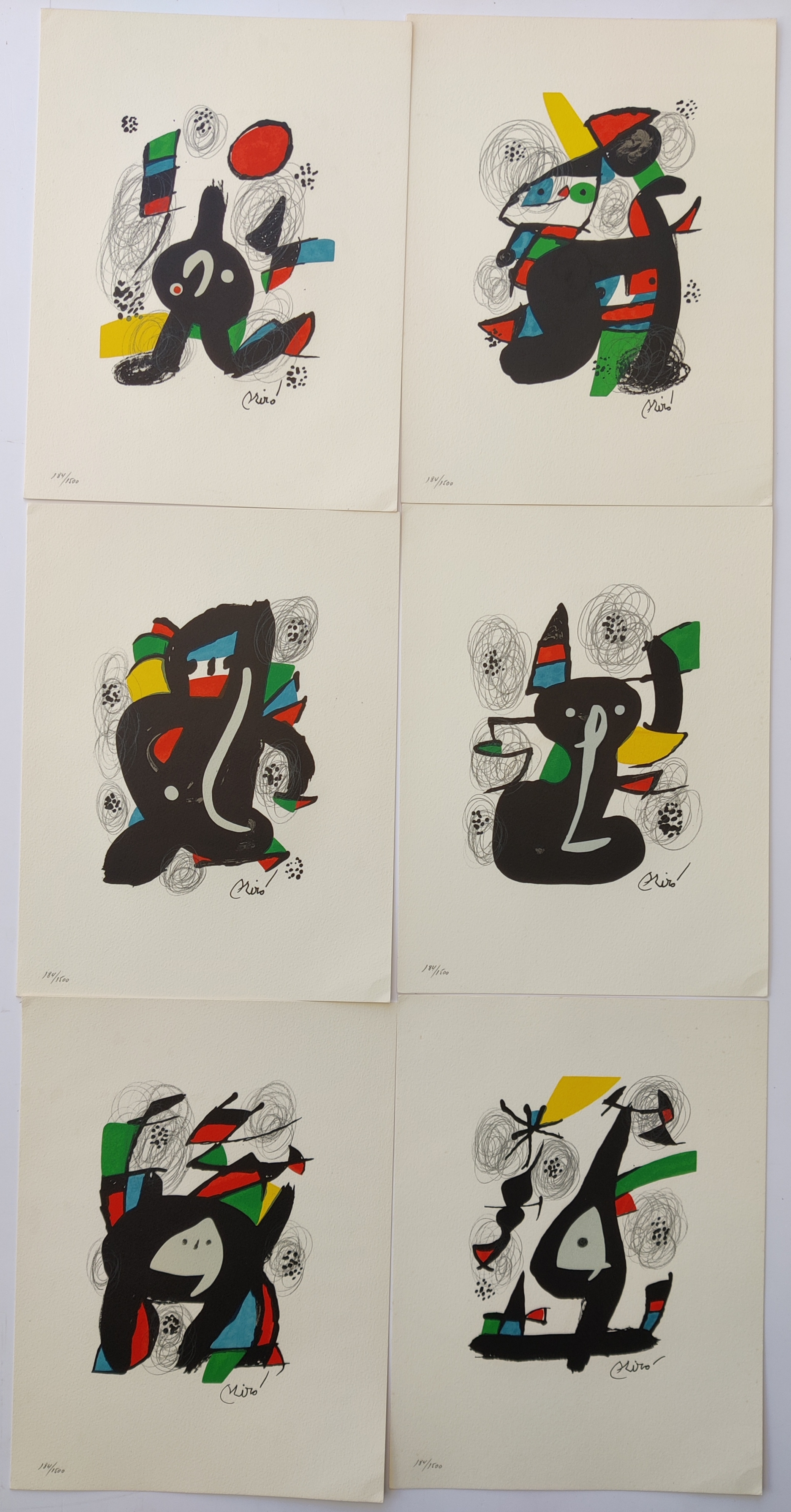A set of six black and white prints on a white wall.
