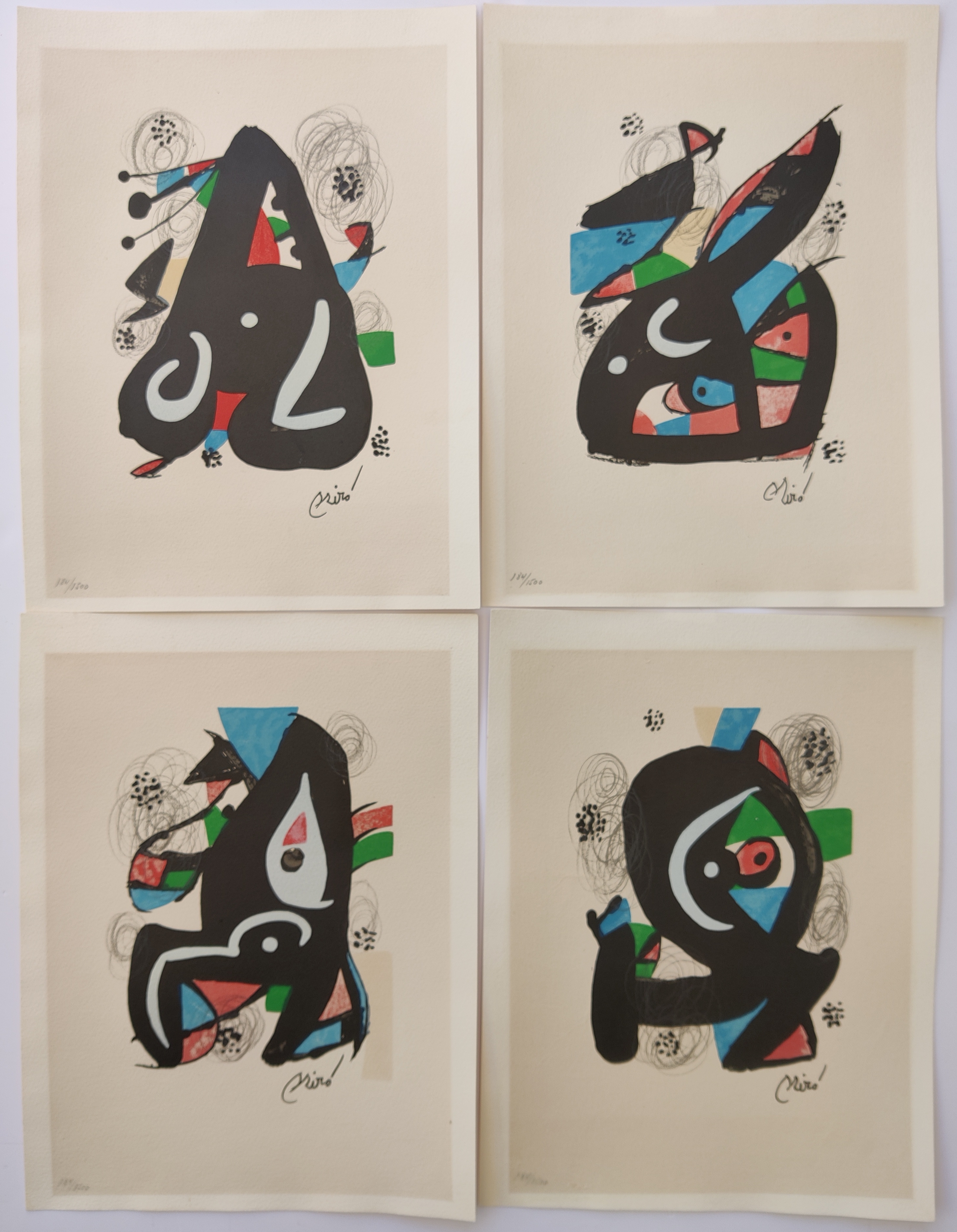 A set of six black and white prints on a white wall.