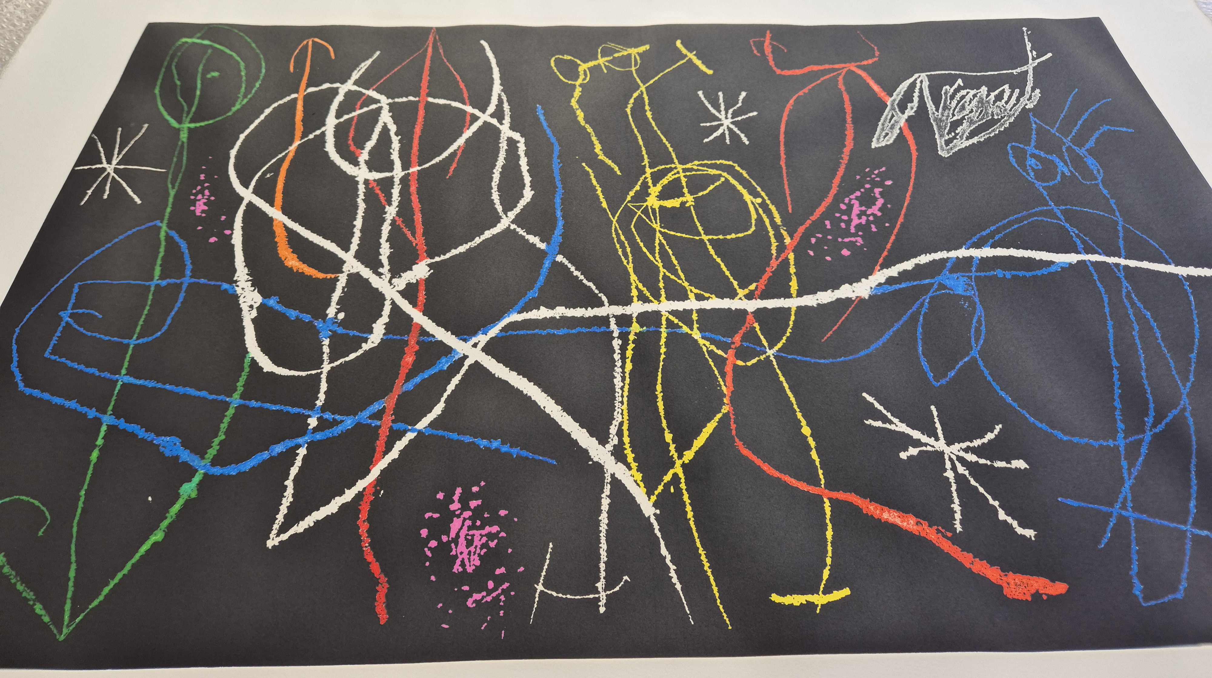A dynamic abstract composition featuring a chaotic web of colorful lines on a dark background.