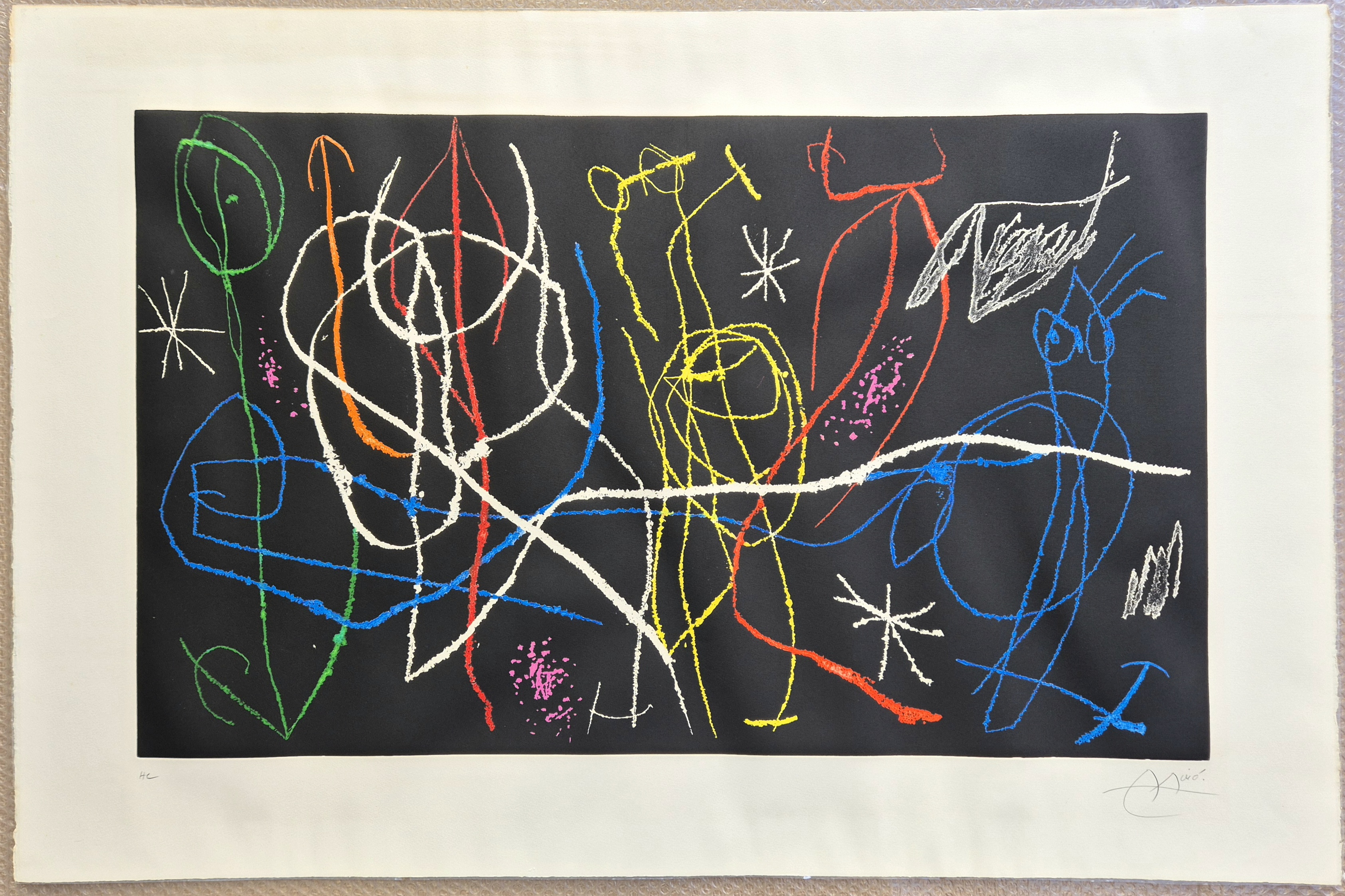 A dynamic abstract composition featuring a chaotic web of colorful lines on a dark background.