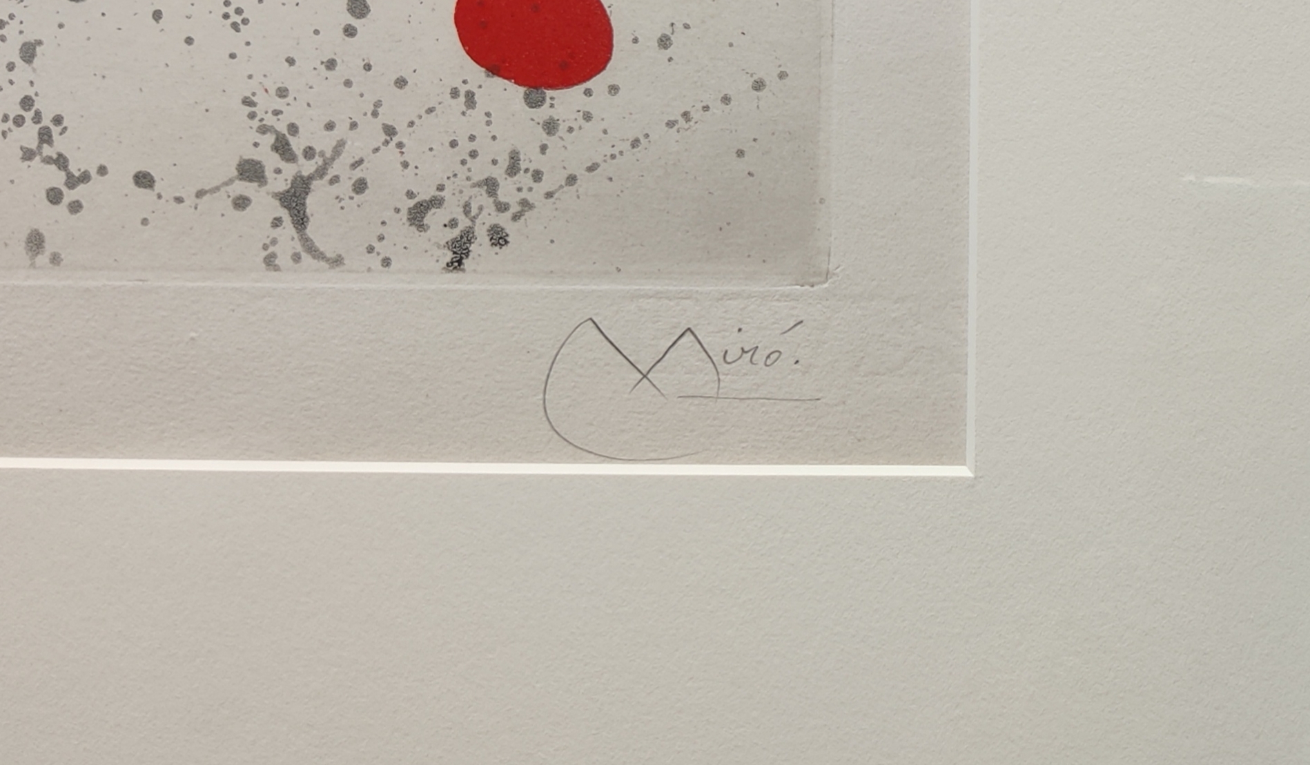 A black and white painting with a red dot in the middle.