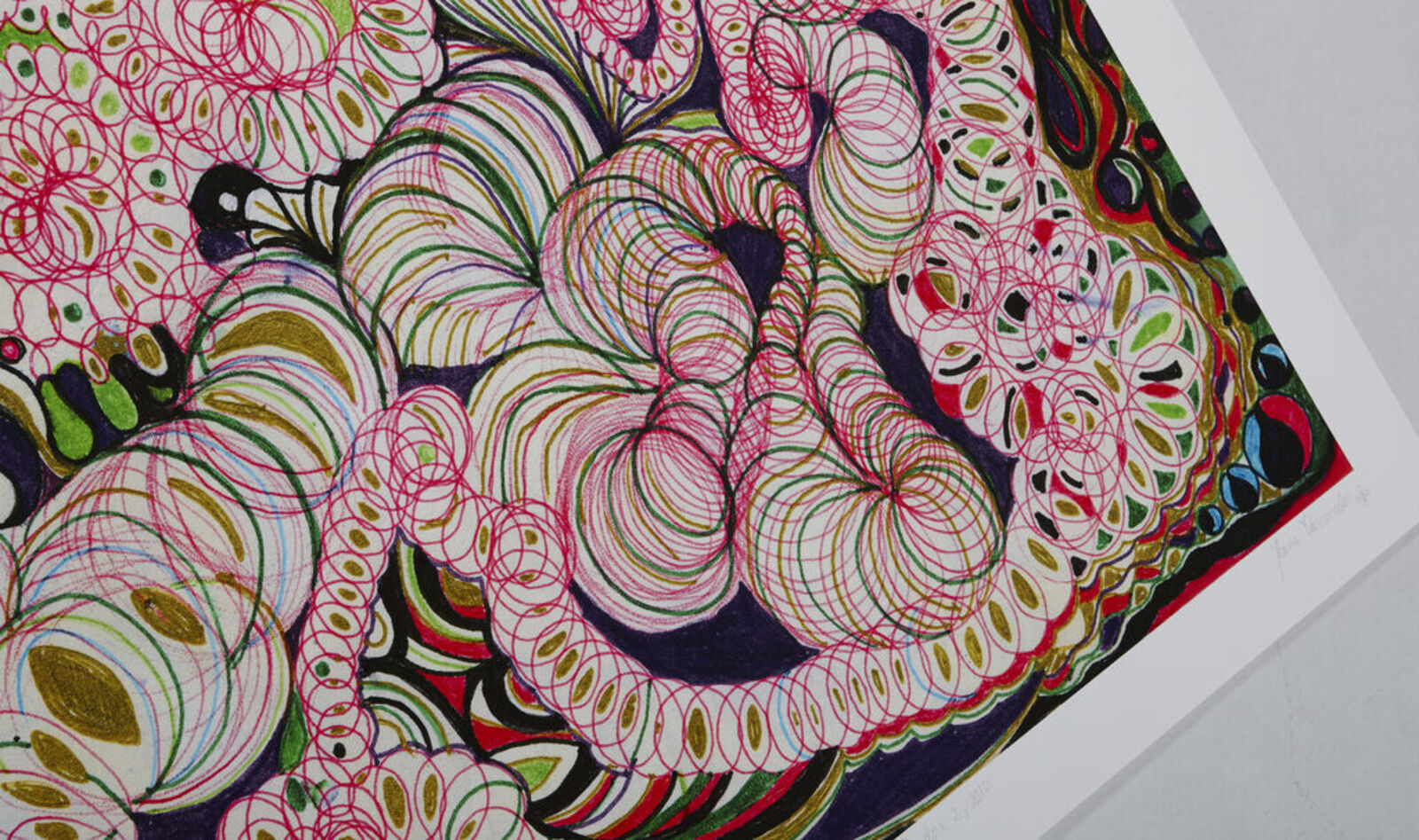 A woman standing in front of a painting on a wall.