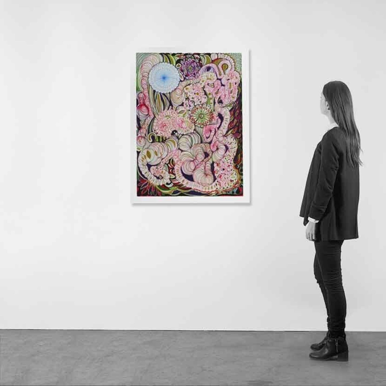 A woman standing in front of a painting on a wall.
