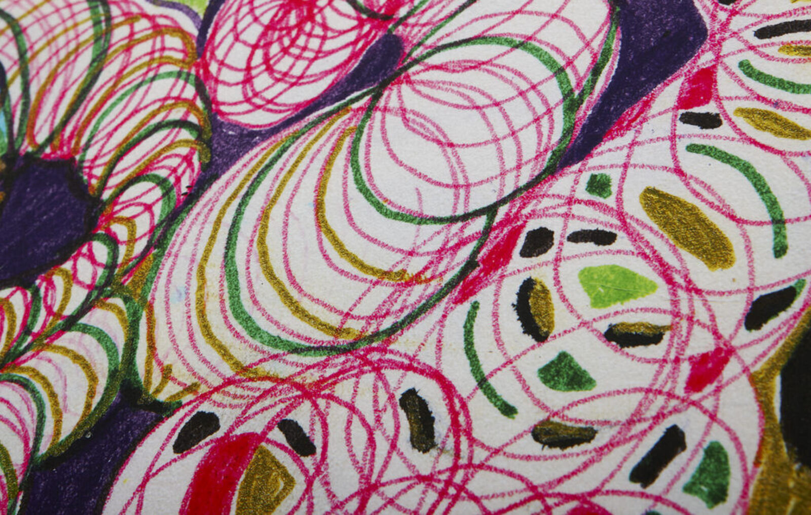 A woman standing in front of a painting on a wall.