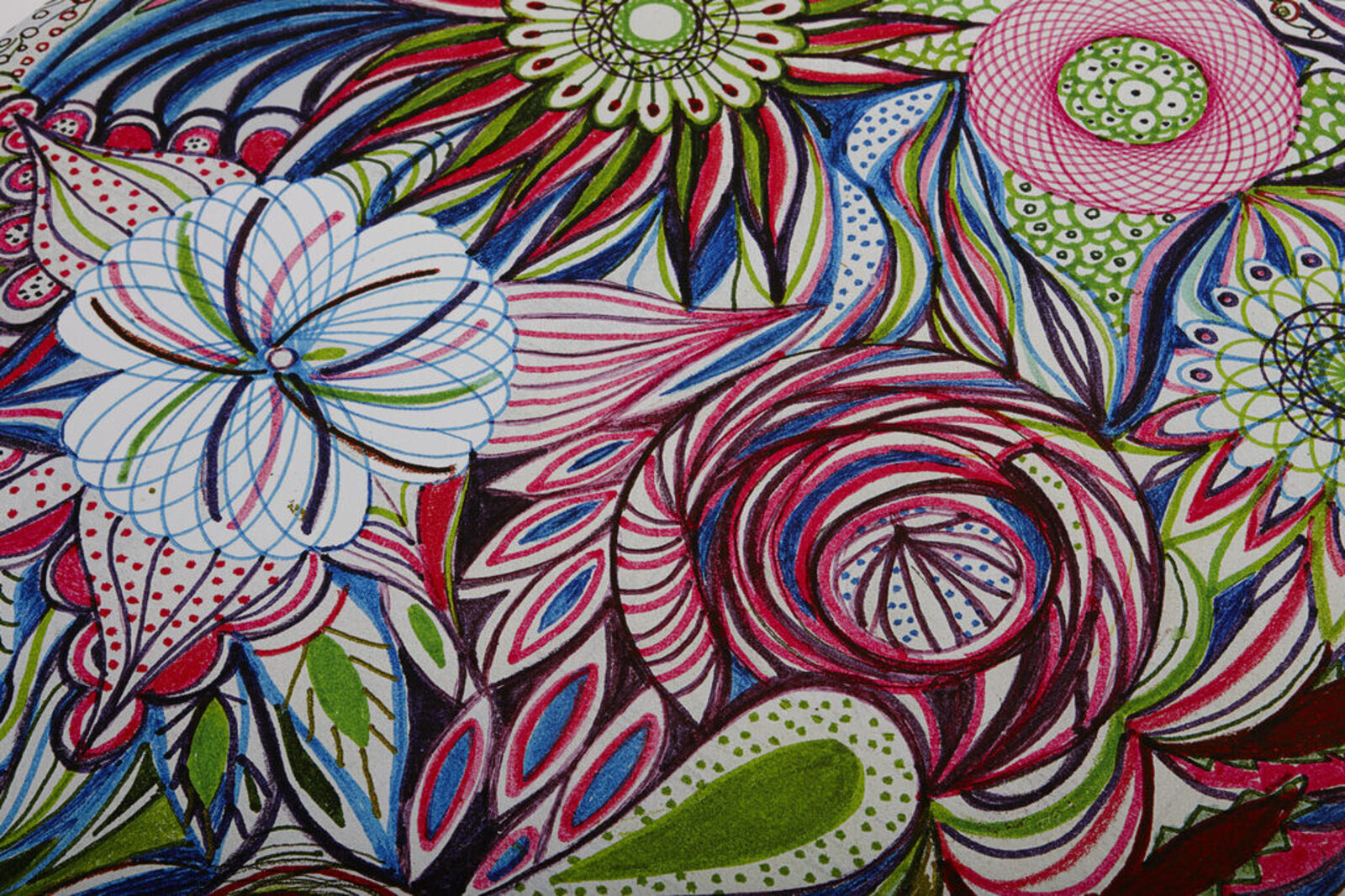 A woman standing in front of a painting on a wall.