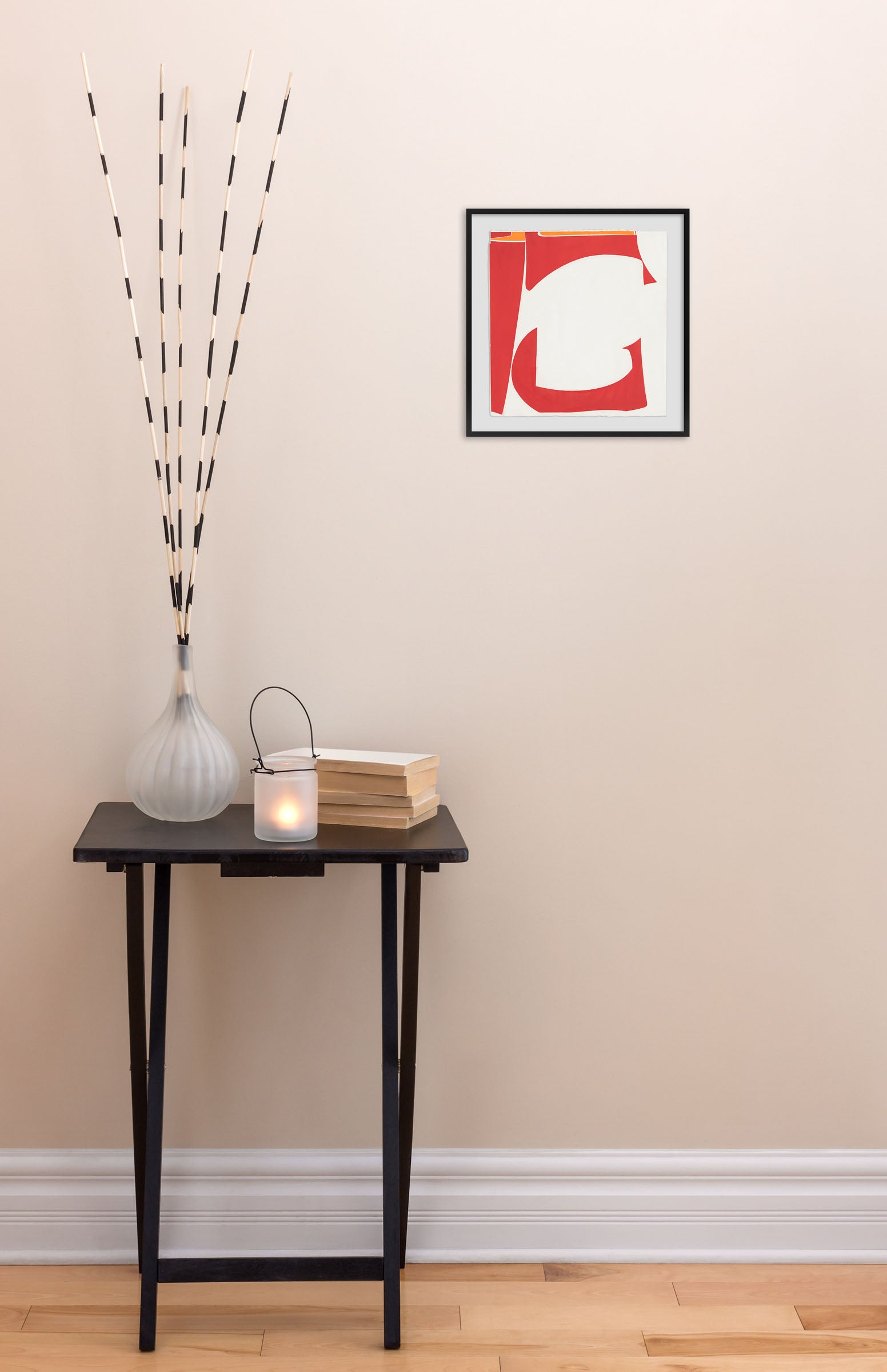 A red and white painting on a white wall.