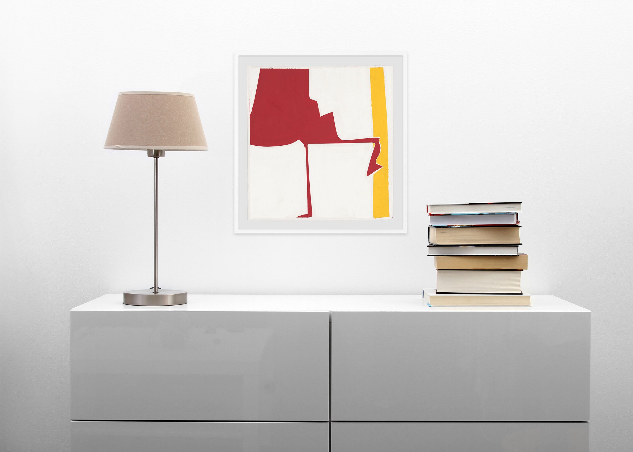 A red and yellow painting on a white wall.
