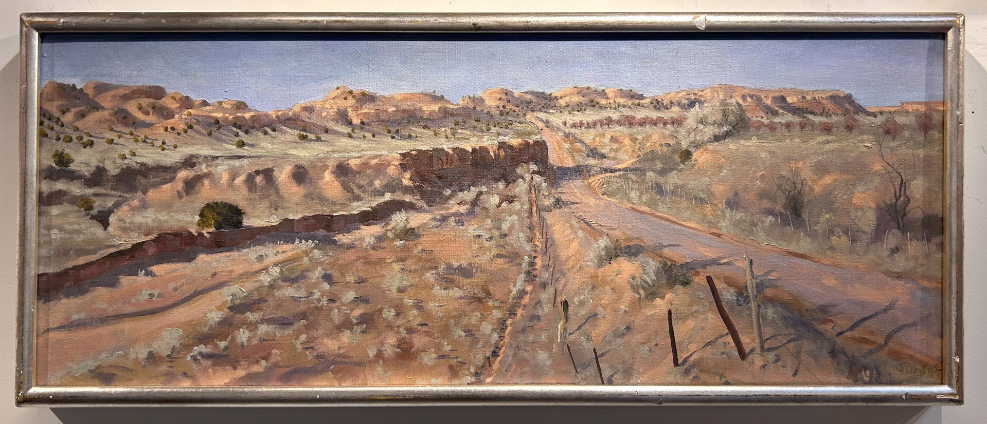 A painting of a dirt road in the desert.