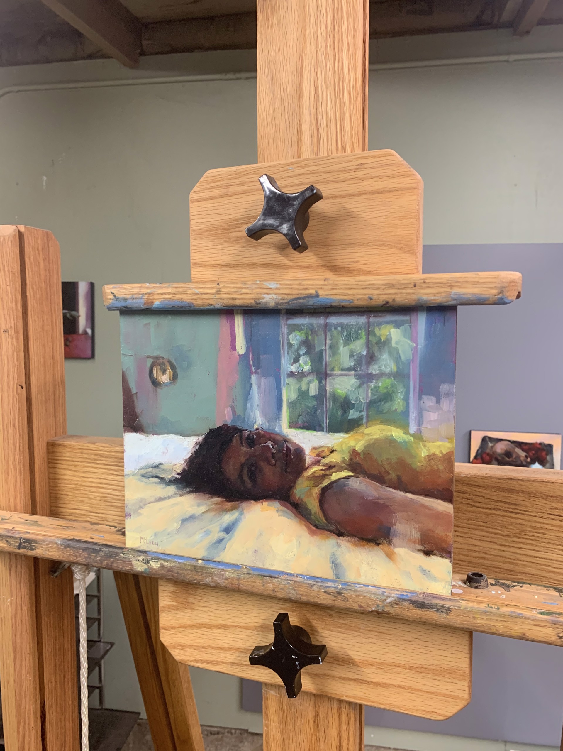 A painting of a woman laying on a bed.