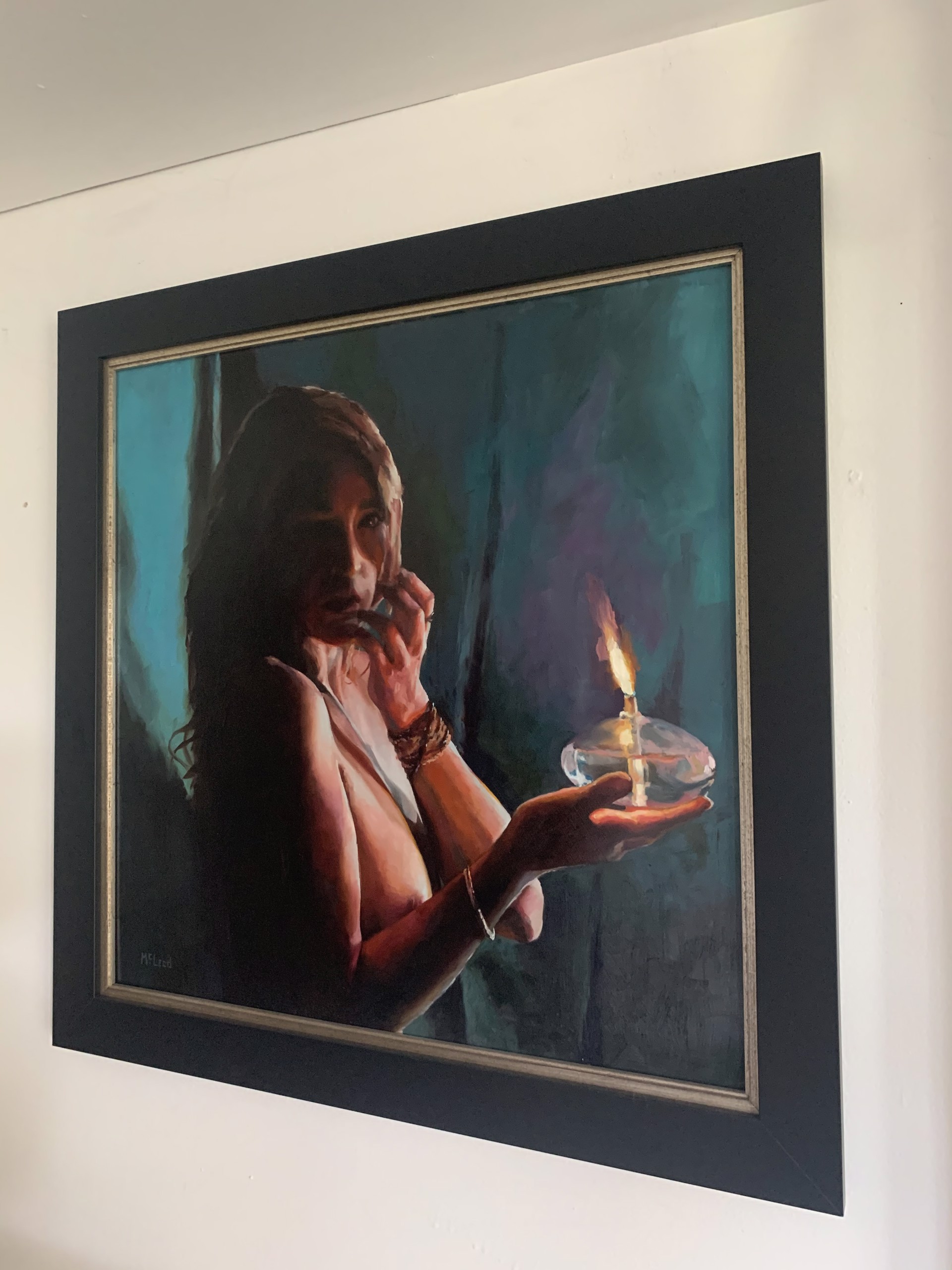 A contemplative figure holding a lit candle in a moody, teal-toned painting.
