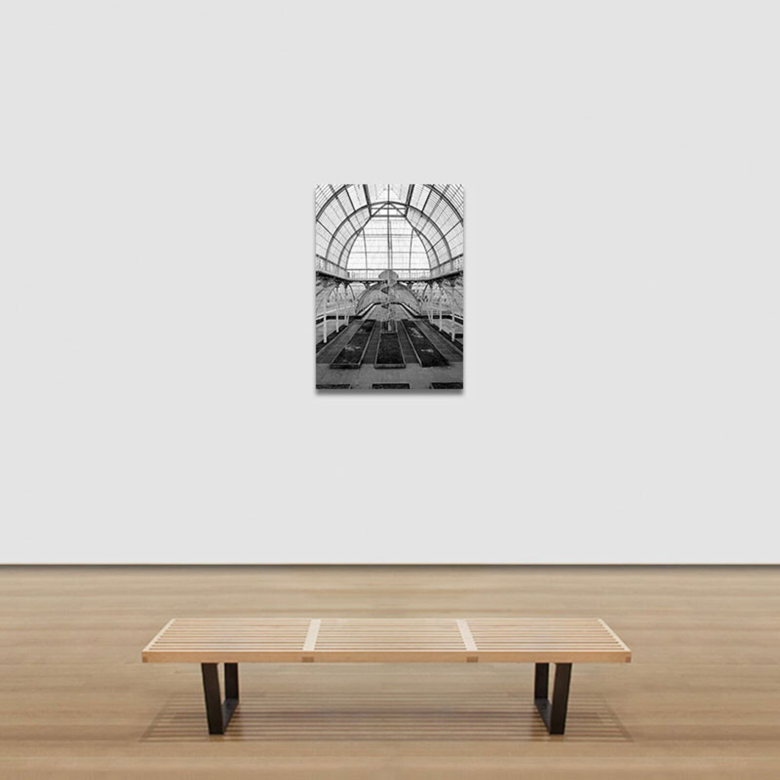 A black and white photo of a greenhouse with a spiral staircase.
