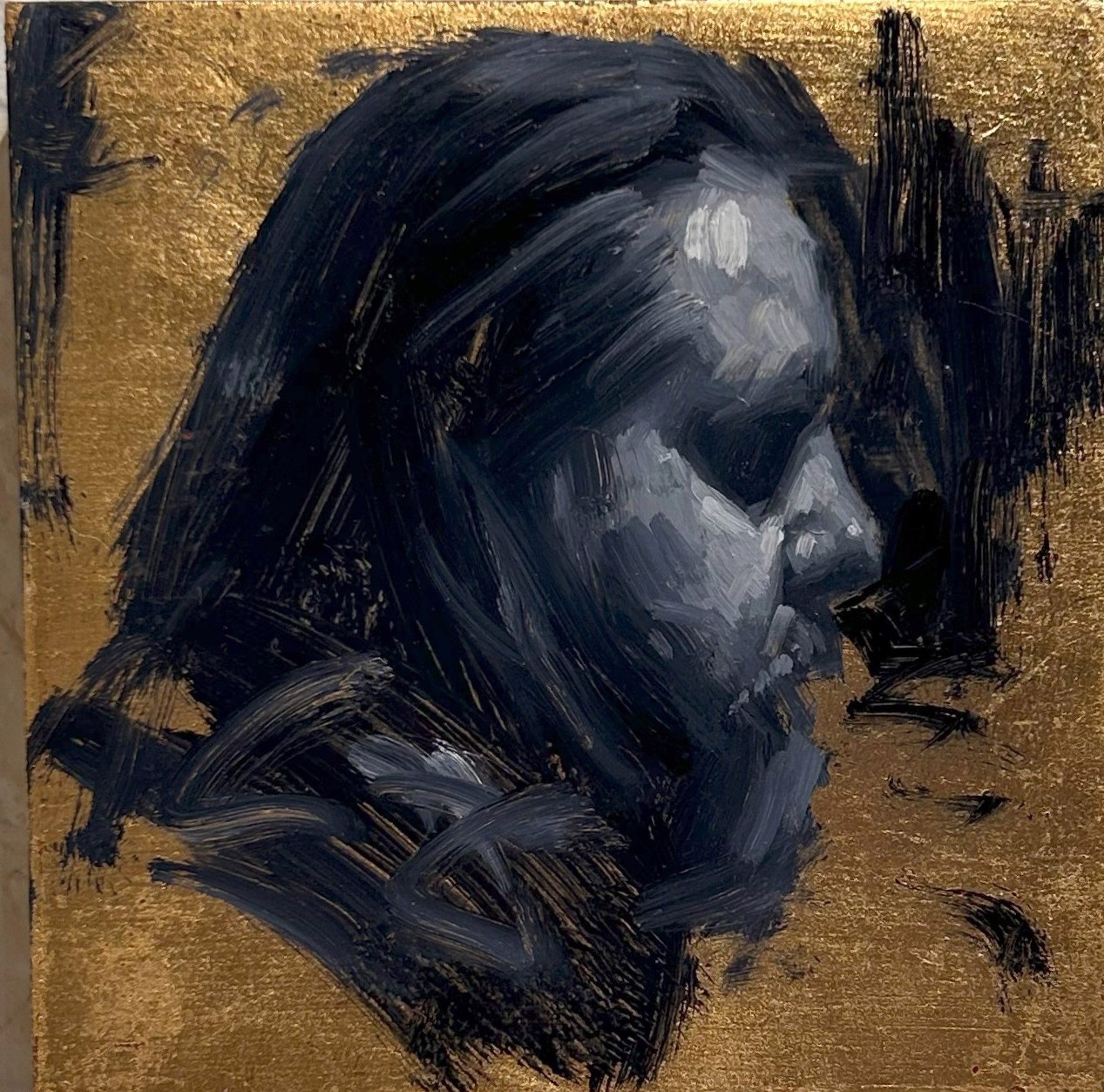 A painting of a man's face on a gold background.