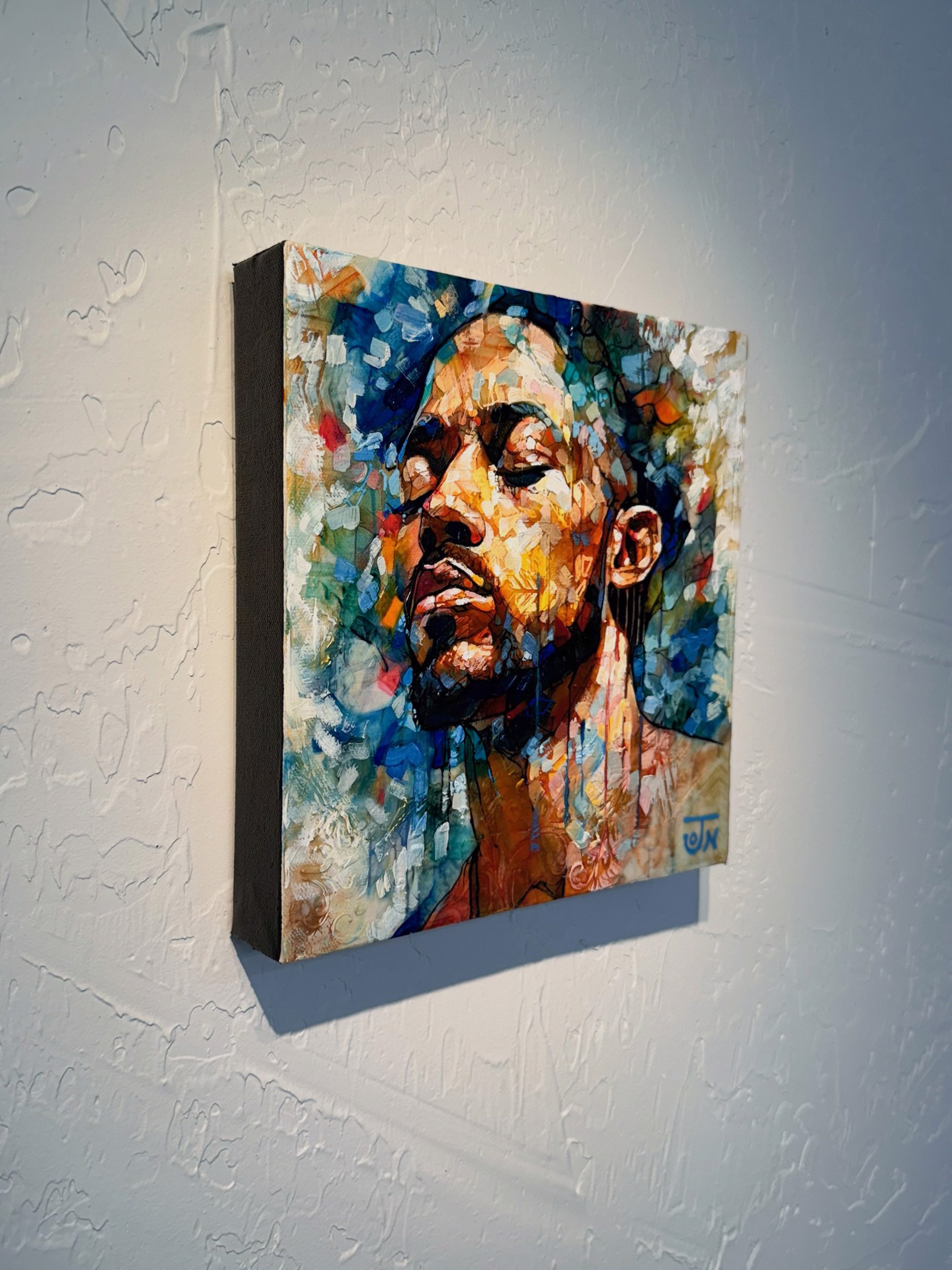 A painting of a man with his eyes closed.