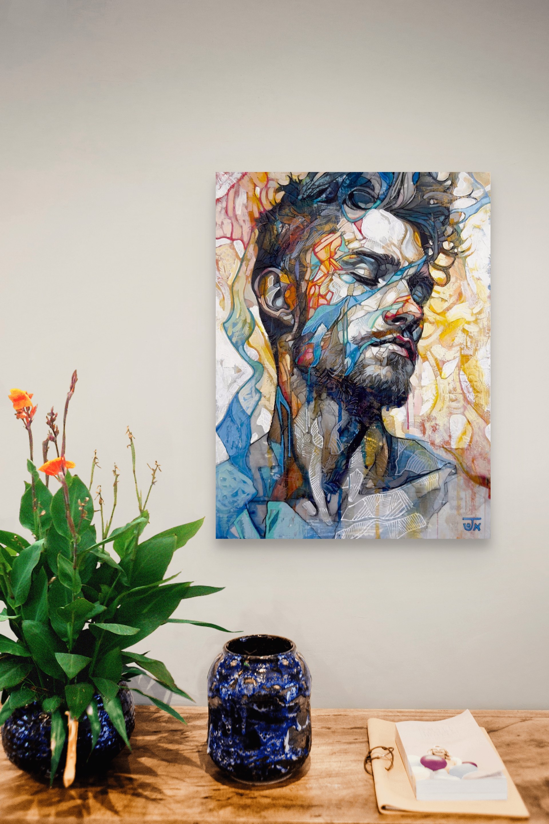 A portrait of a bearded figure with a fragmented, abstract face against a vibrant background.