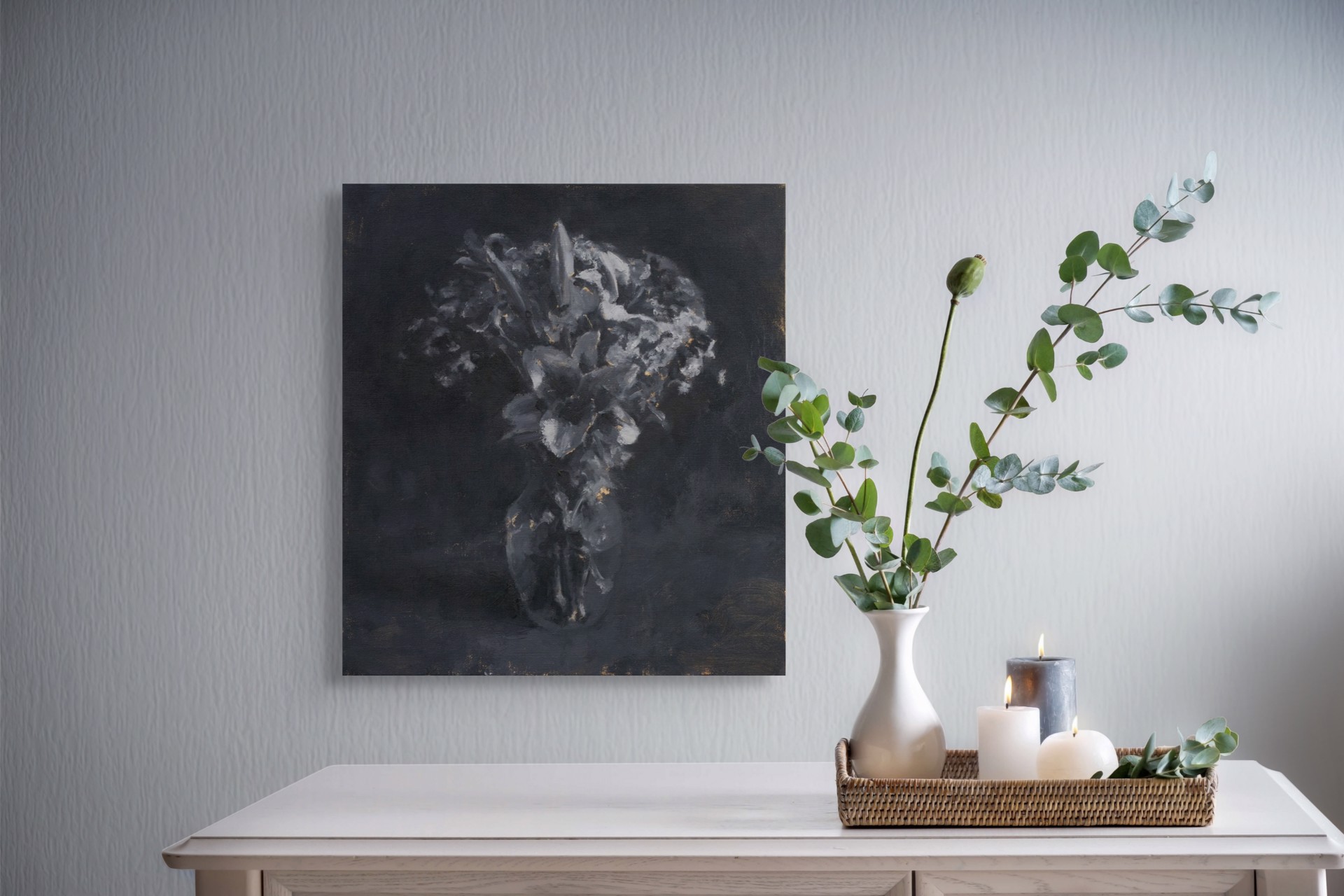 A monochromatic still life of lilies in a vase against a dark background.