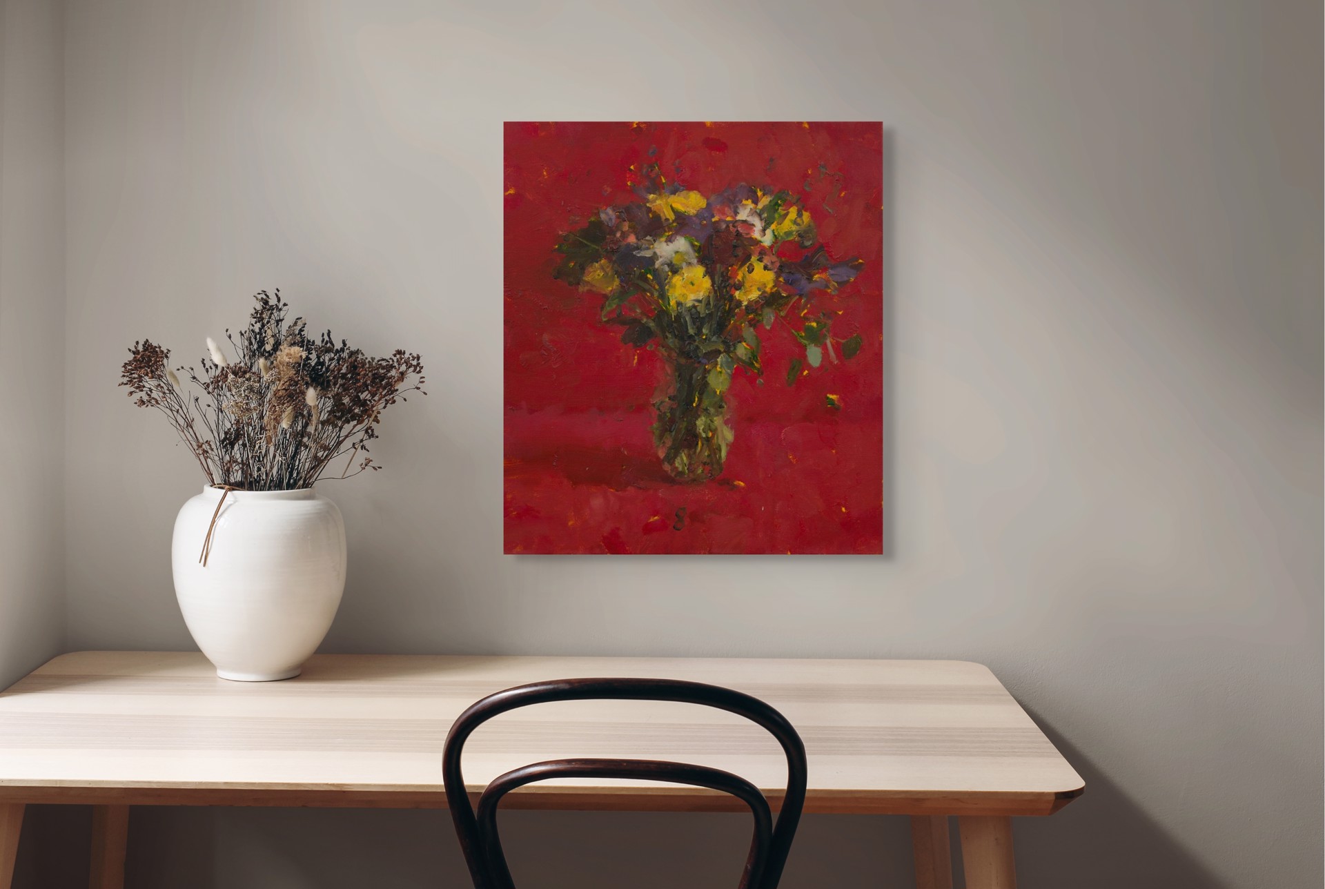 A vibrant still life of a colorful bouquet in a vase against a bold red background.