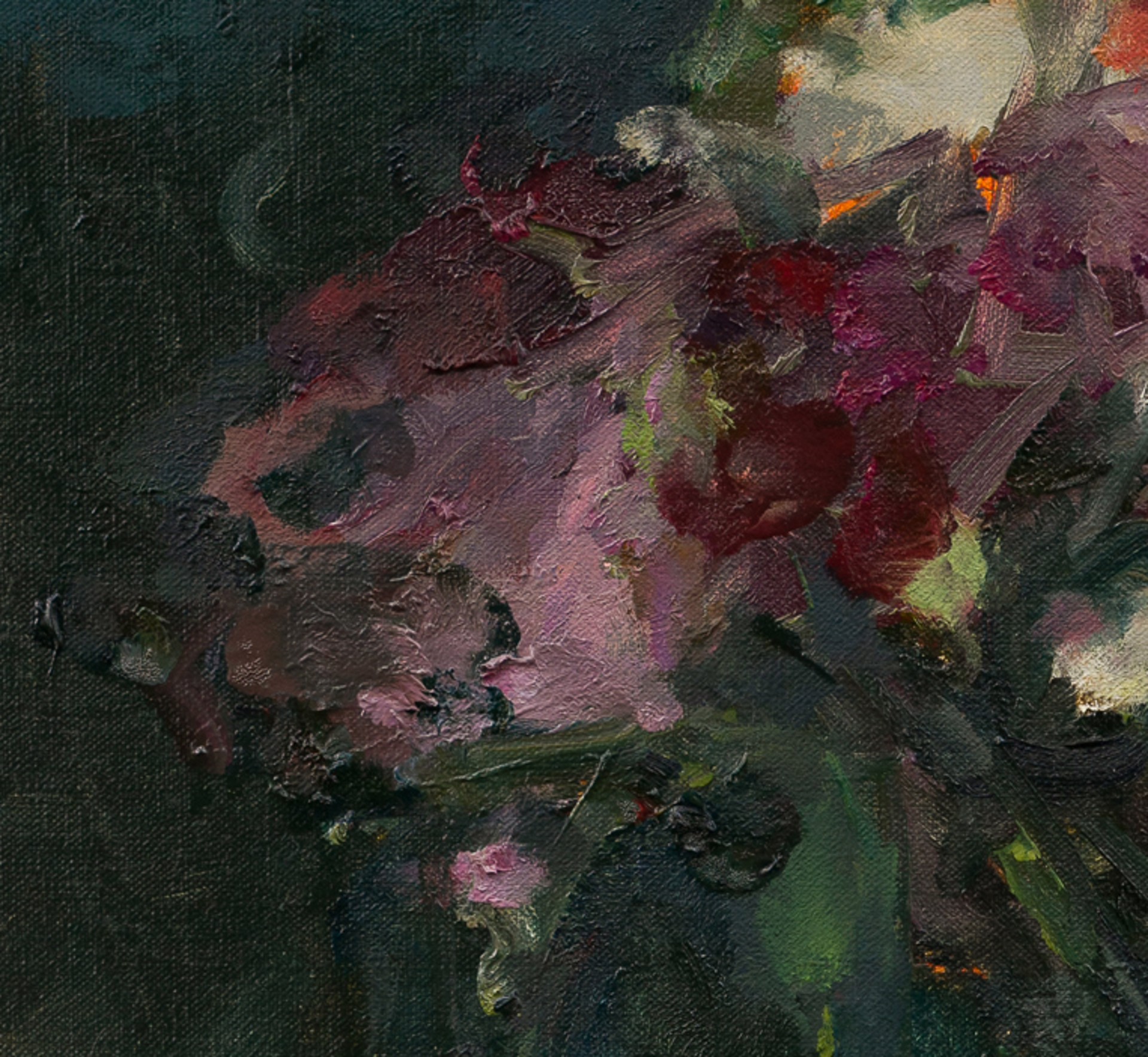 A vibrant bouquet of flowers in a vase against a dark teal background.