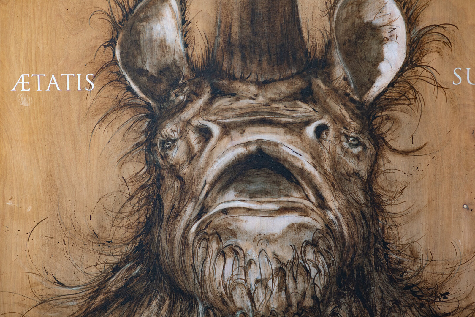 A hyper-realistic charcoal sketch of a rhinoceros head on a wood-grain background with white text.