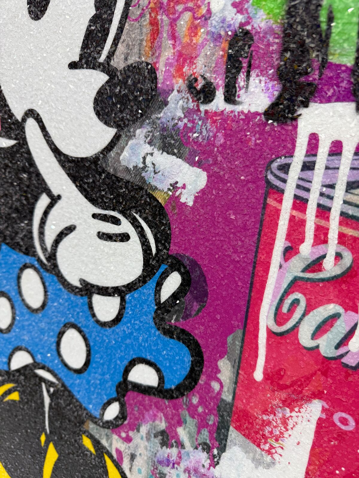 A painting of two Mickey and Minnie Mouse on a wall.