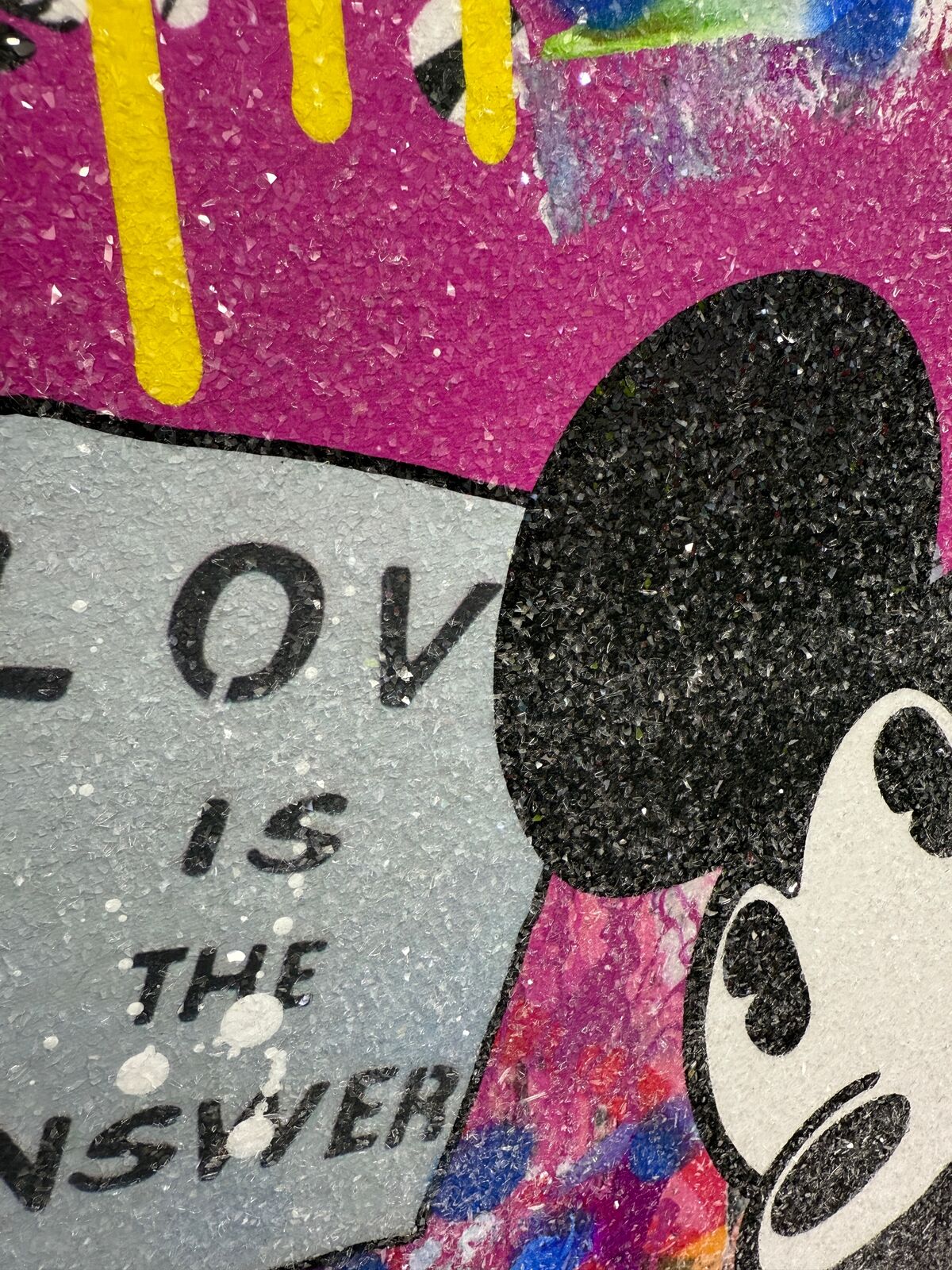 A painting of two Mickey and Minnie Mouse on a wall.