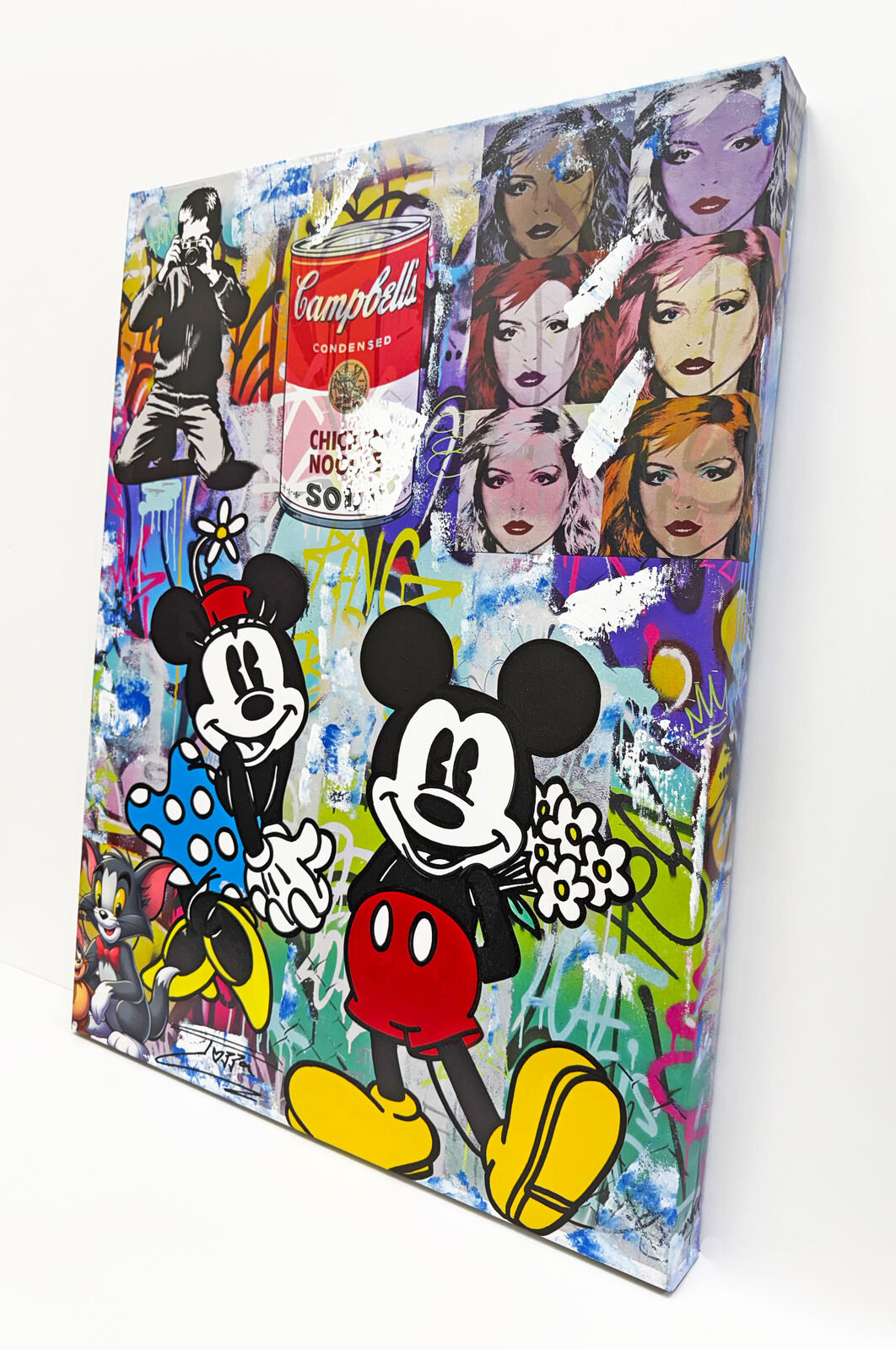 A painting of Mickey Mouse and other cartoon characters on a wall.