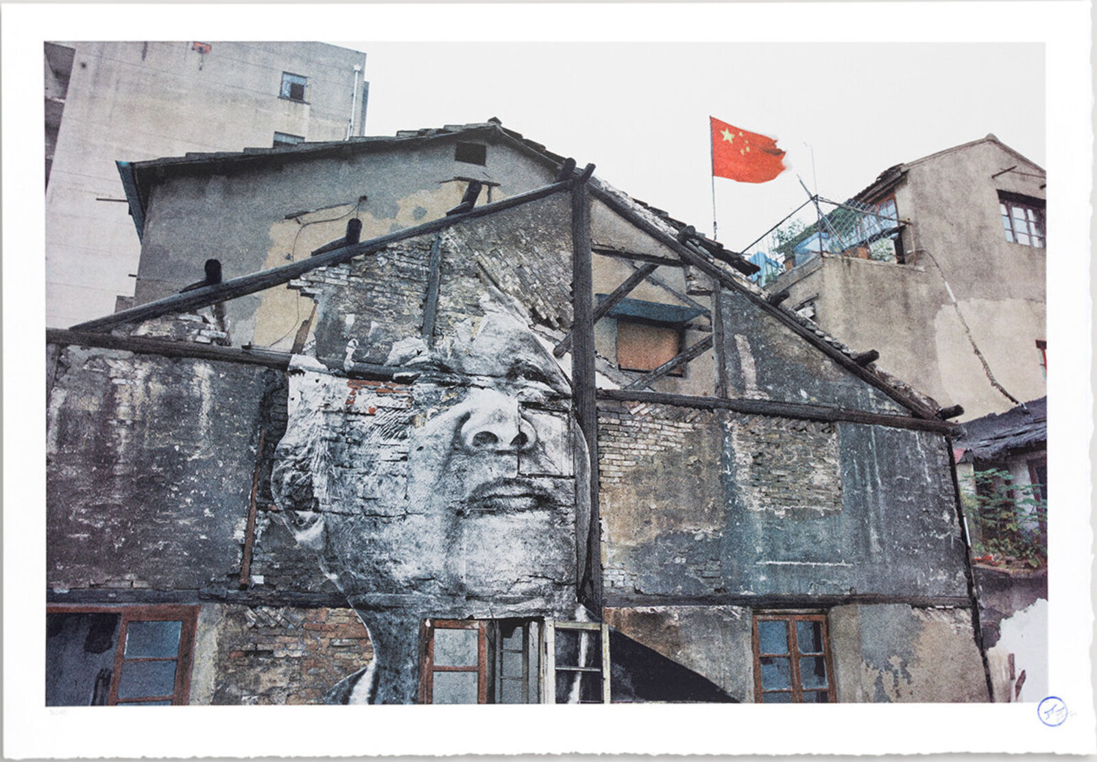 A picture of a building with a chinese flag on top of it.