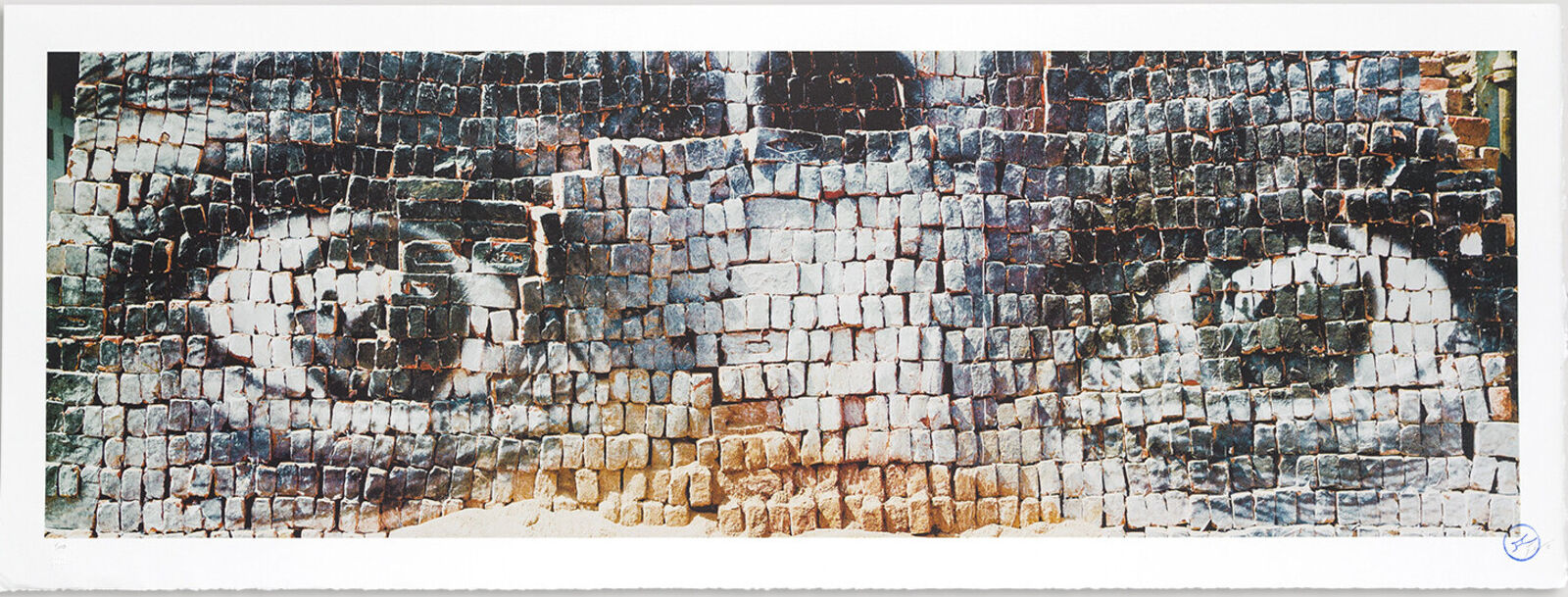 A picture of a brick wall with a face painted on it.