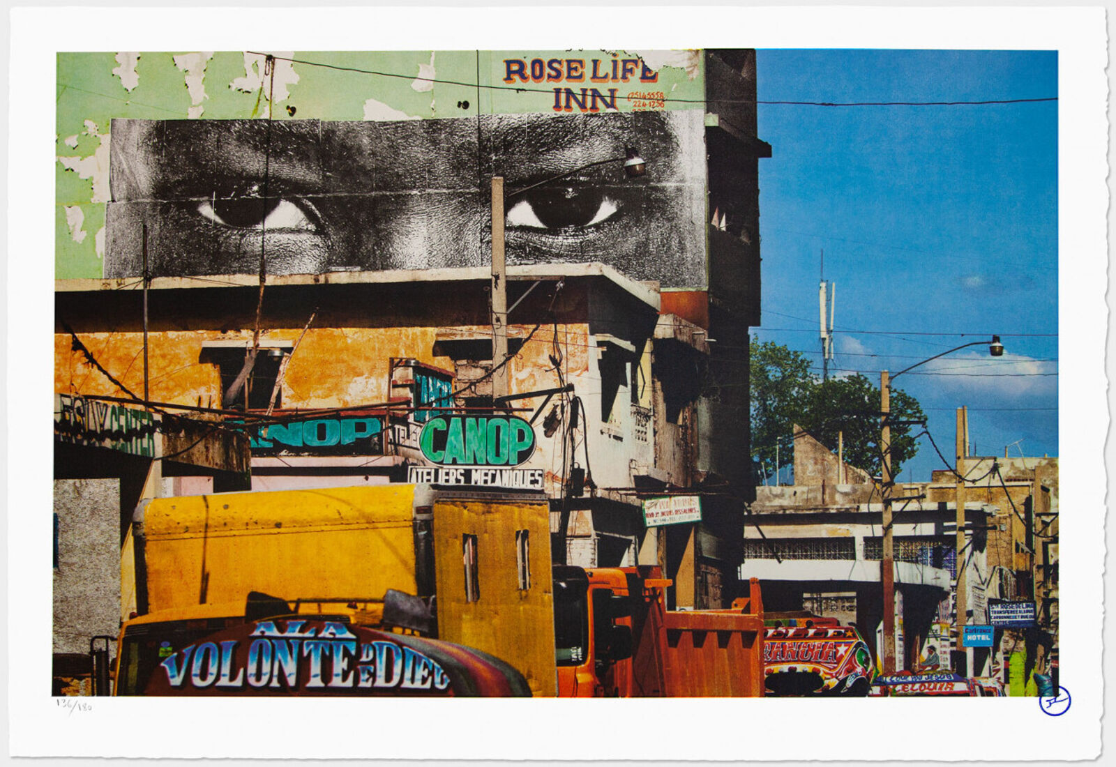 A picture of a city street with a truck parked in front of it.