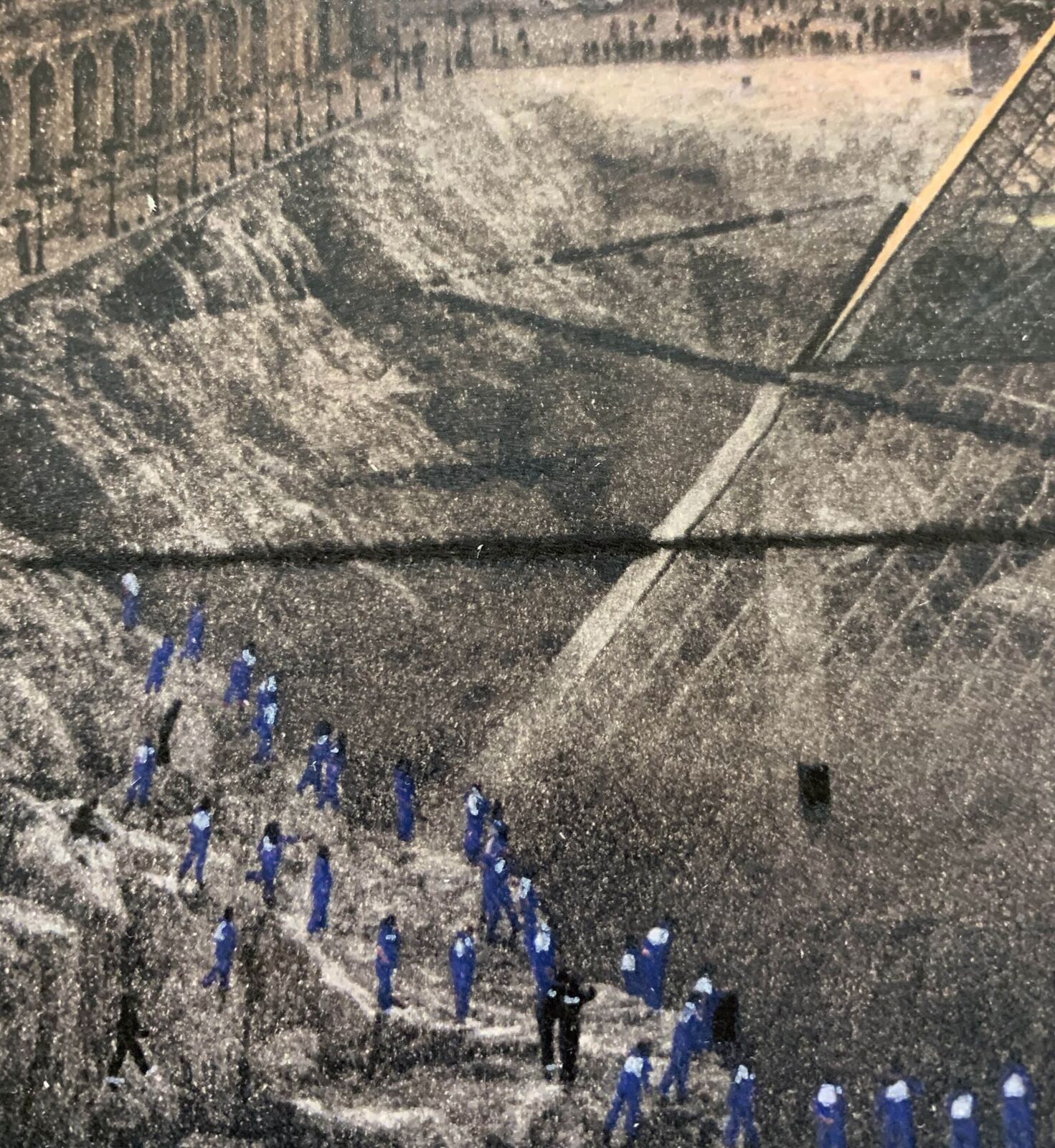 A group of people standing in front of a pyramid.