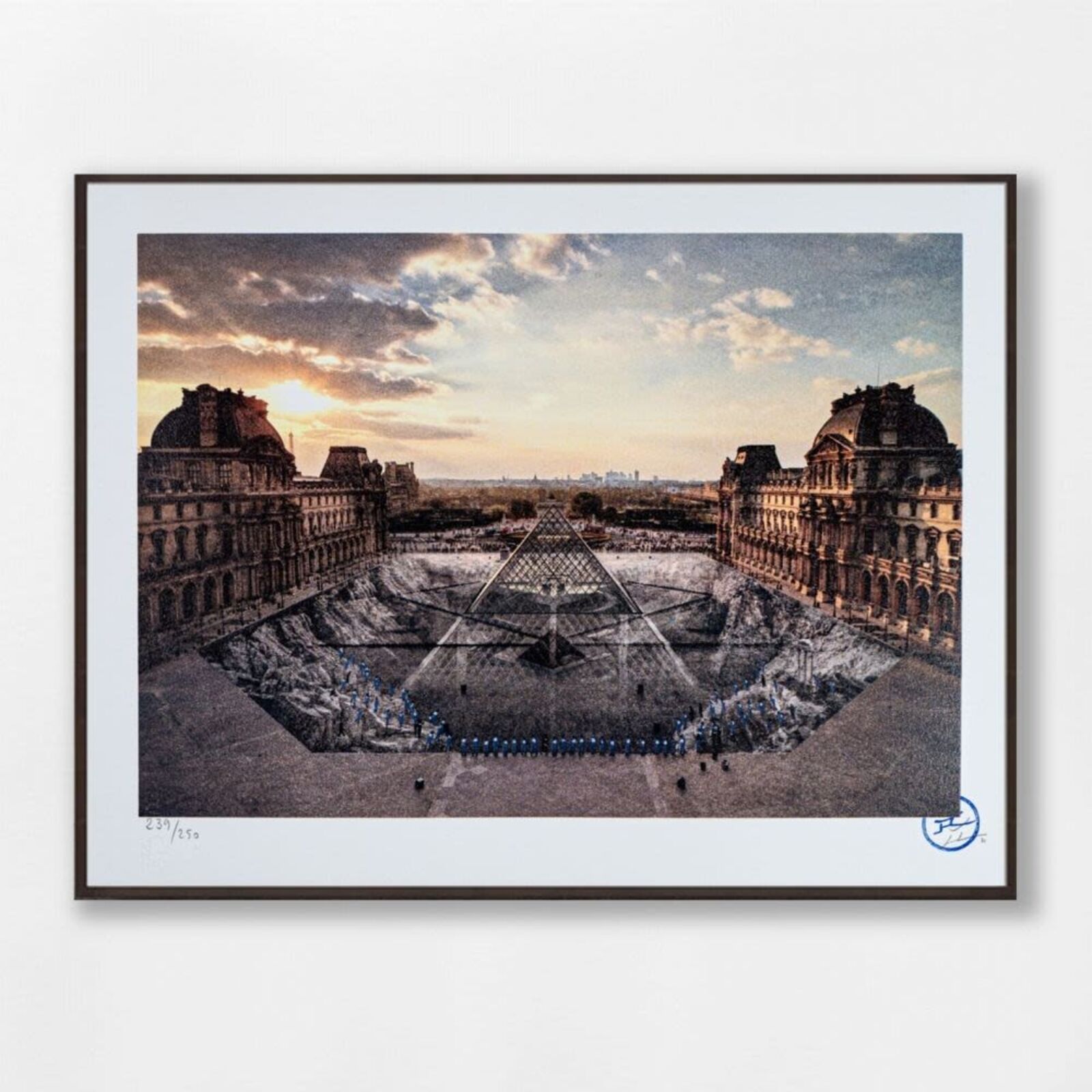 A group of people standing in front of a pyramid.