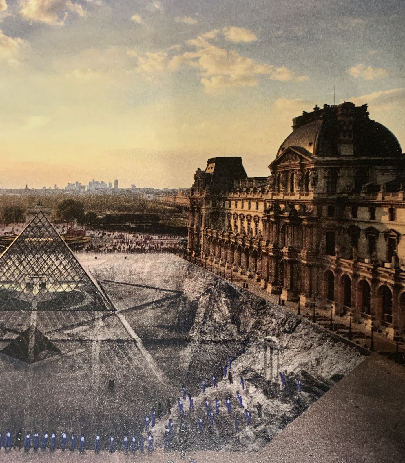 A group of people standing in front of a pyramid.
