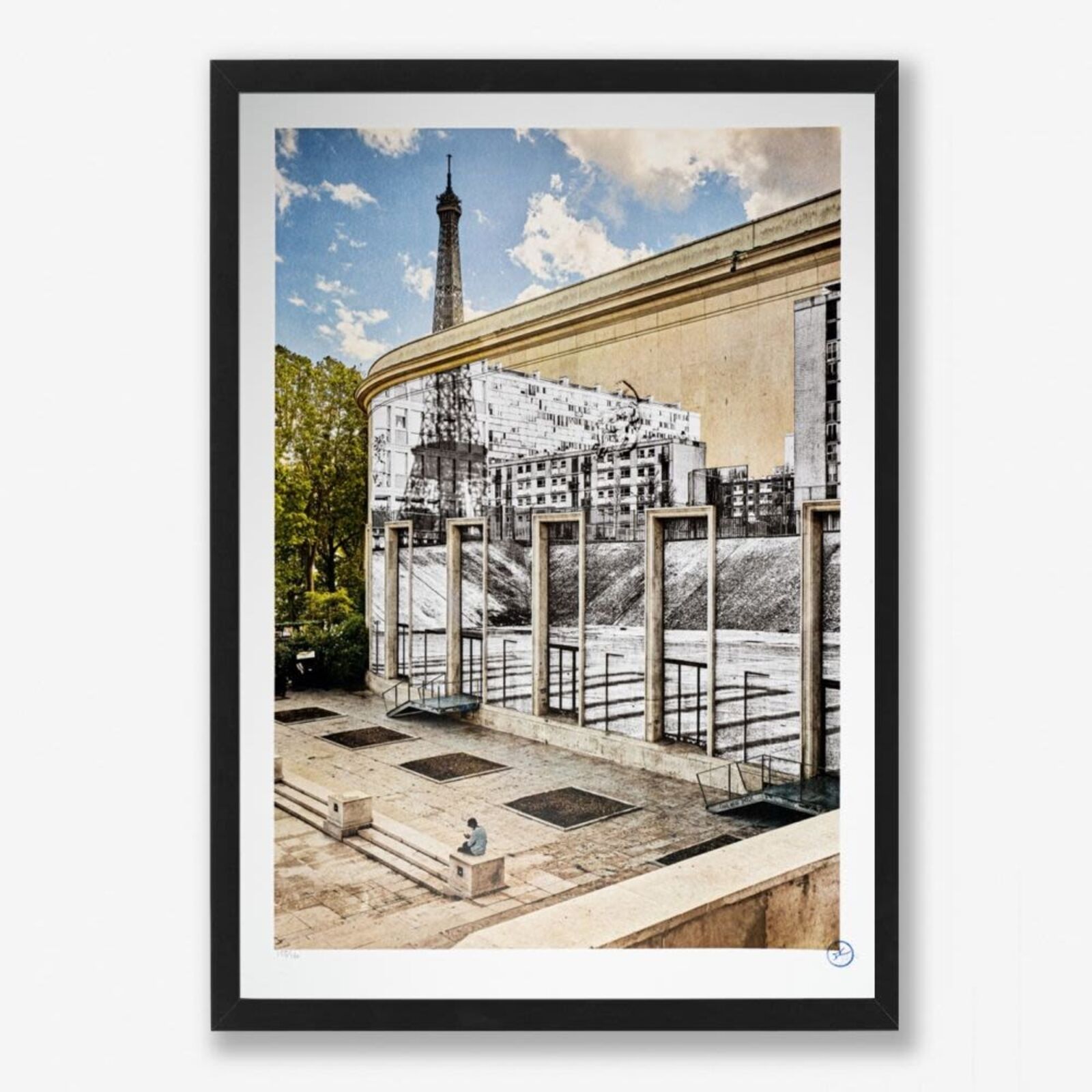 A man sitting on a bench in front of a mural of the Eiffel Tower.