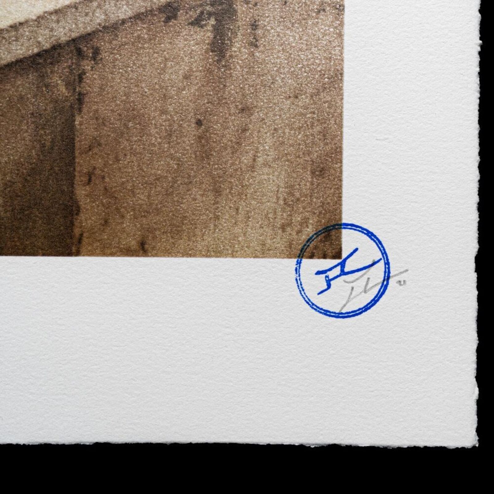 A man sitting on a bench in front of a mural of the Eiffel Tower.