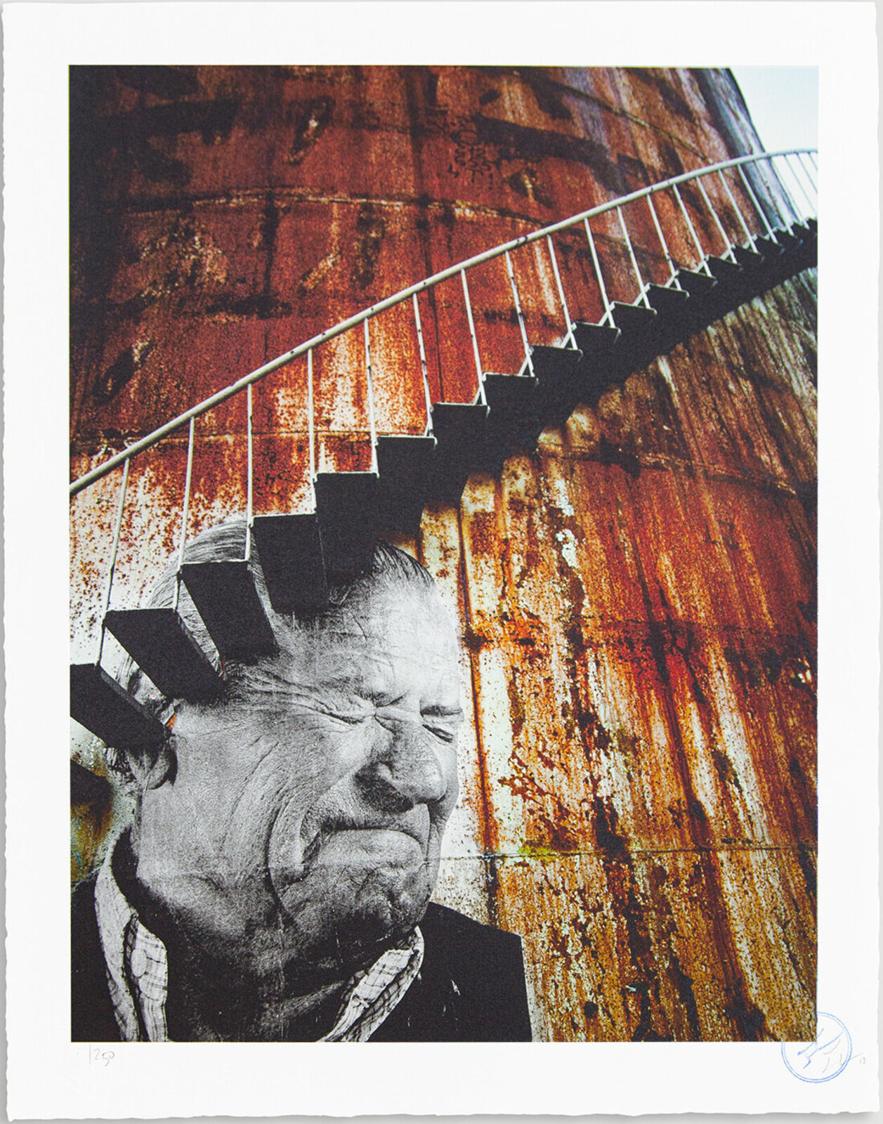 A black and white photo of a man with a spiral staircase.