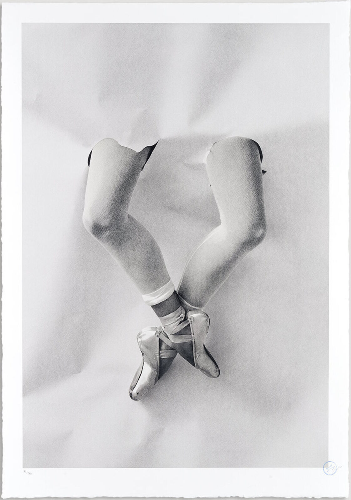 A black and white photo of a pair of ballet shoes.