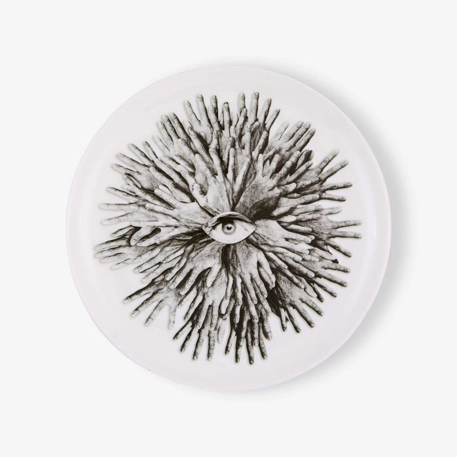 A white plate with a black and white drawing of an eye.