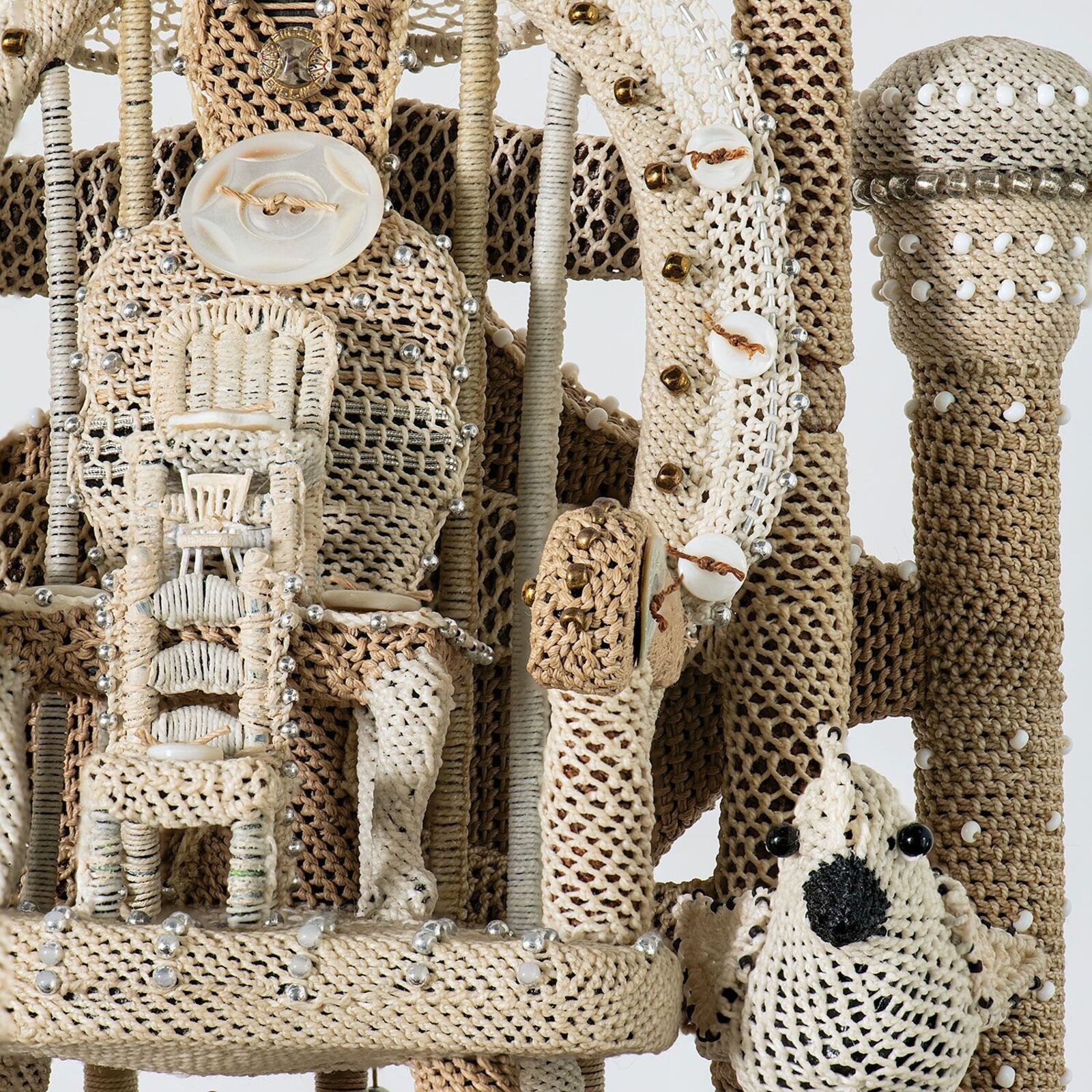 A multi-tiered sculpture resembling a miniature tower or clockwork structure.