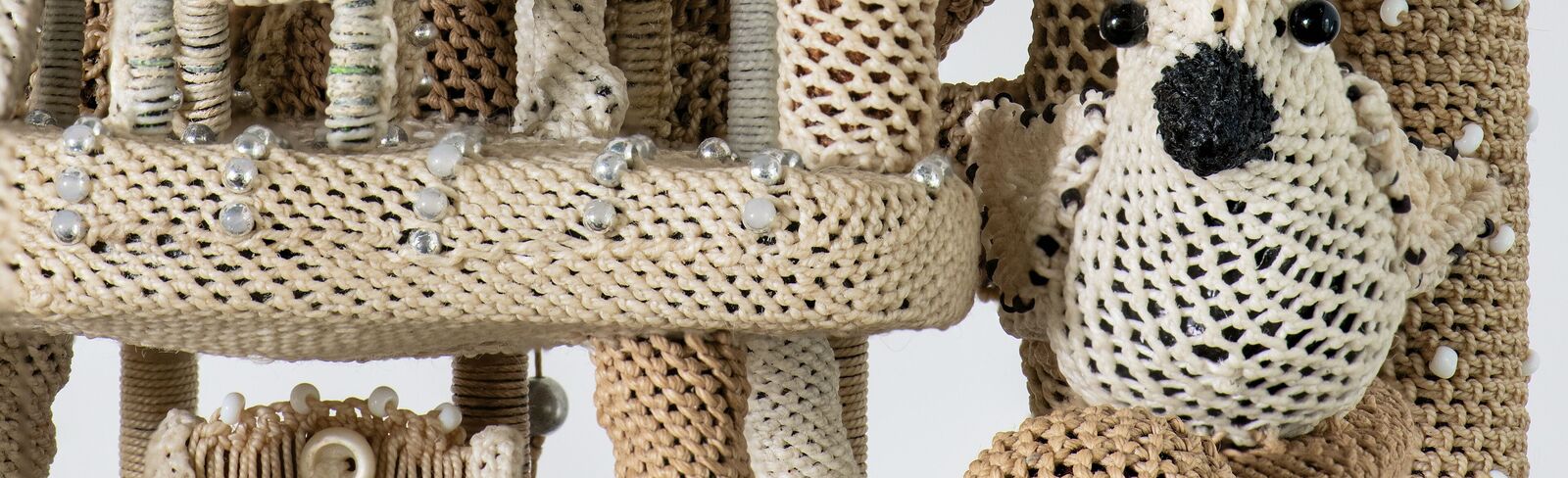 A multi-tiered sculpture resembling a miniature tower or clockwork structure.