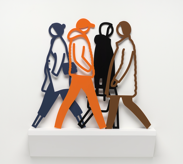 A group of people walking on a white surface.