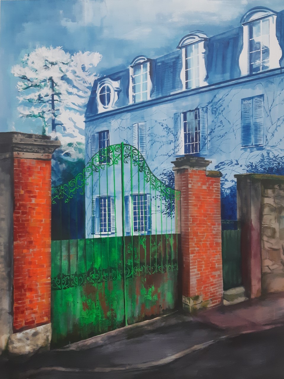 A vibrant street scene featuring a large green gate and a blue building with dormer windows.