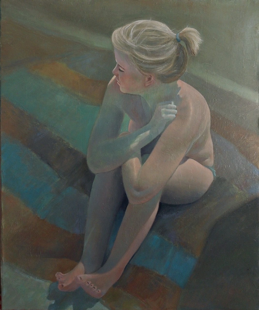 A contemplative figure sits in profile, wrapped in a blanket against a muted background.