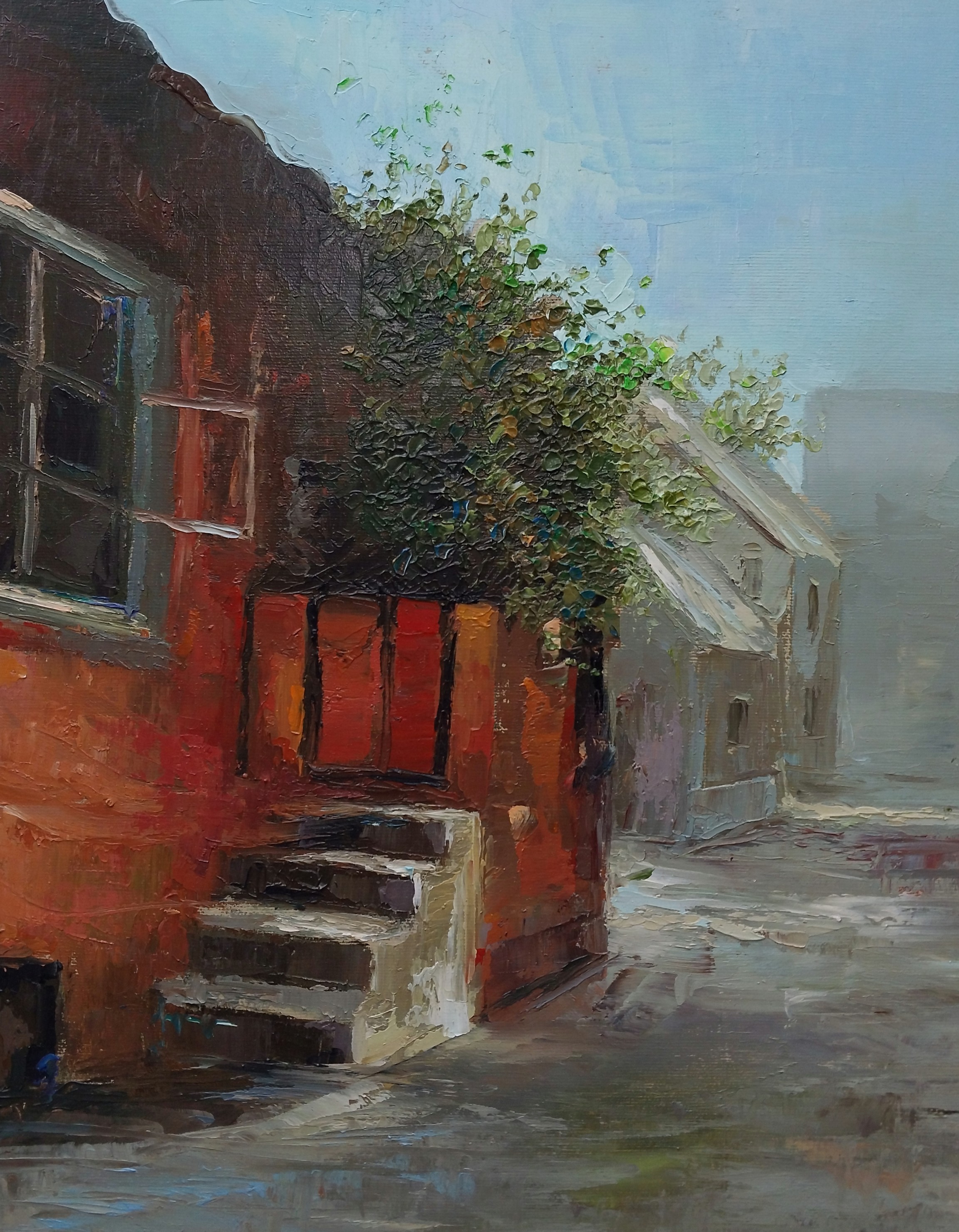 A textured oil painting of a quiet, misty street corner with a red building and green foliage.