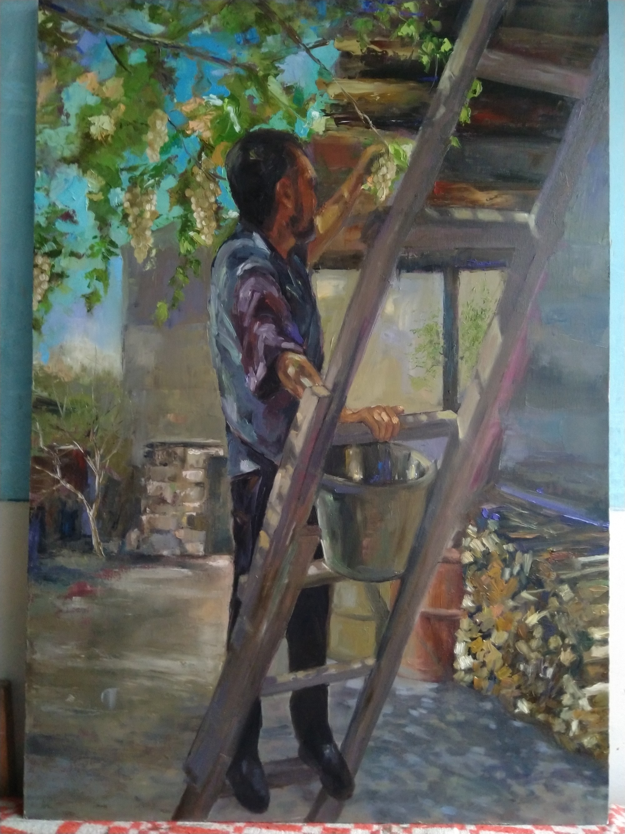 A painterly scene of a figure harvesting grapes on a ladder.